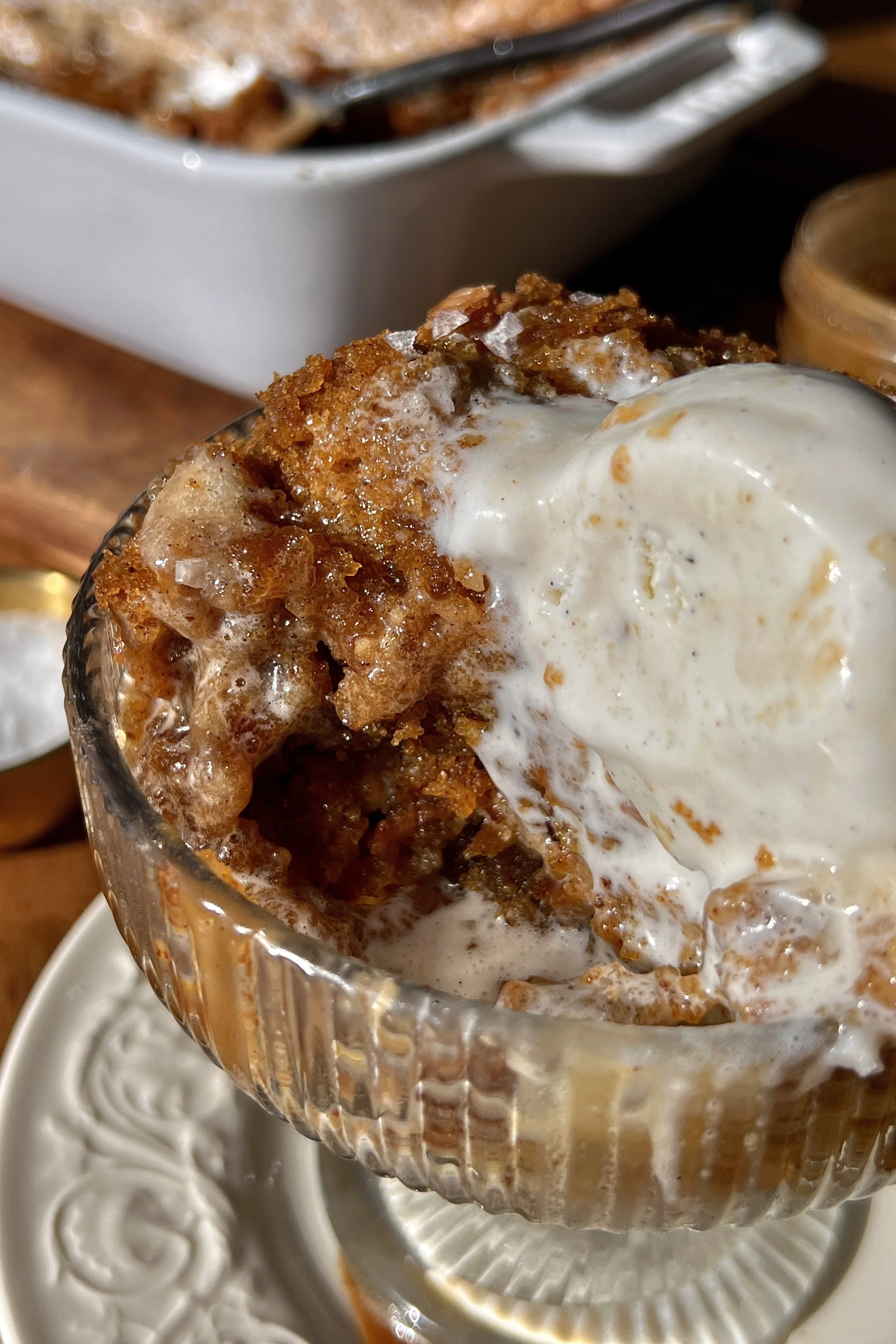 Close-up of a deep dish sweet potato gooey brown butter cake showing the soft and tender spiced brown butter sweet potato base with the crackly gooey cinnamon cream cheese layer on top.
