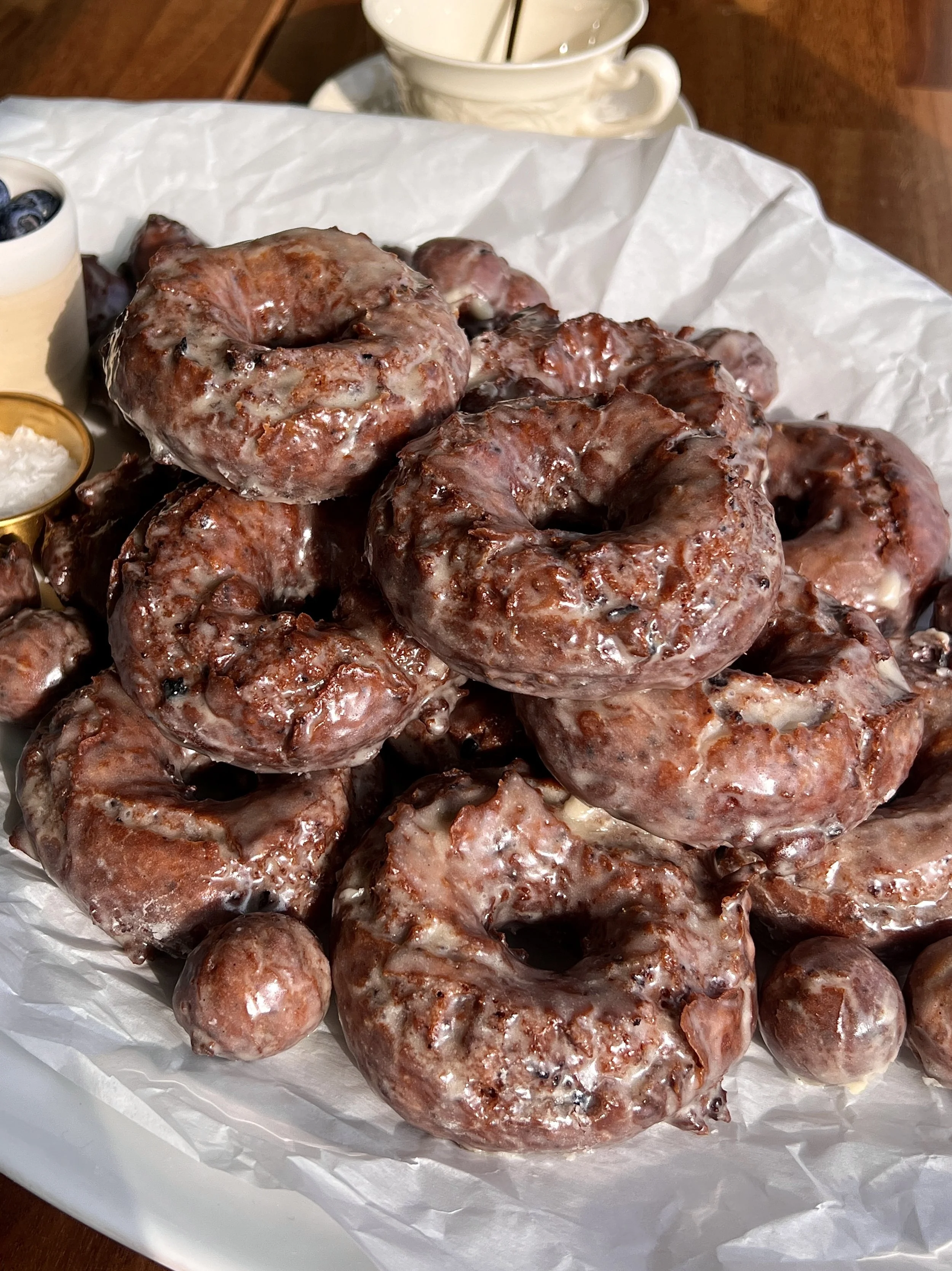 Old-fashioned blueberry cake donuts with vanilla bean glaze and signature cracked tops.