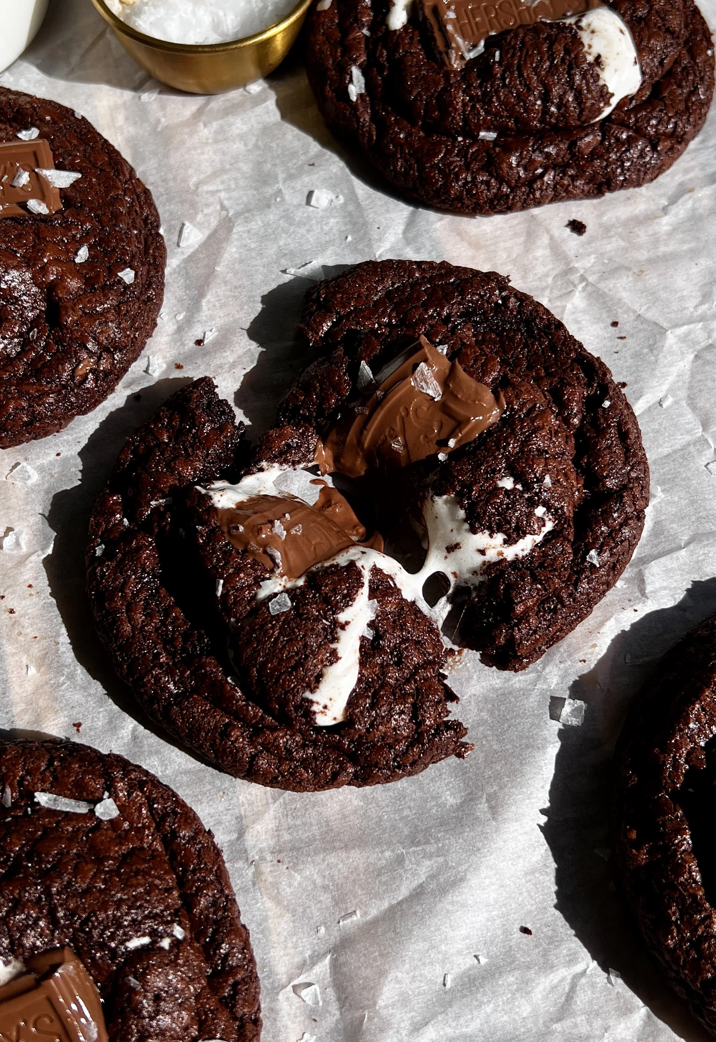 Fudgy s’mores brownie cookies with crispy edges, gooey marshmallow, and melted milk chocolate.