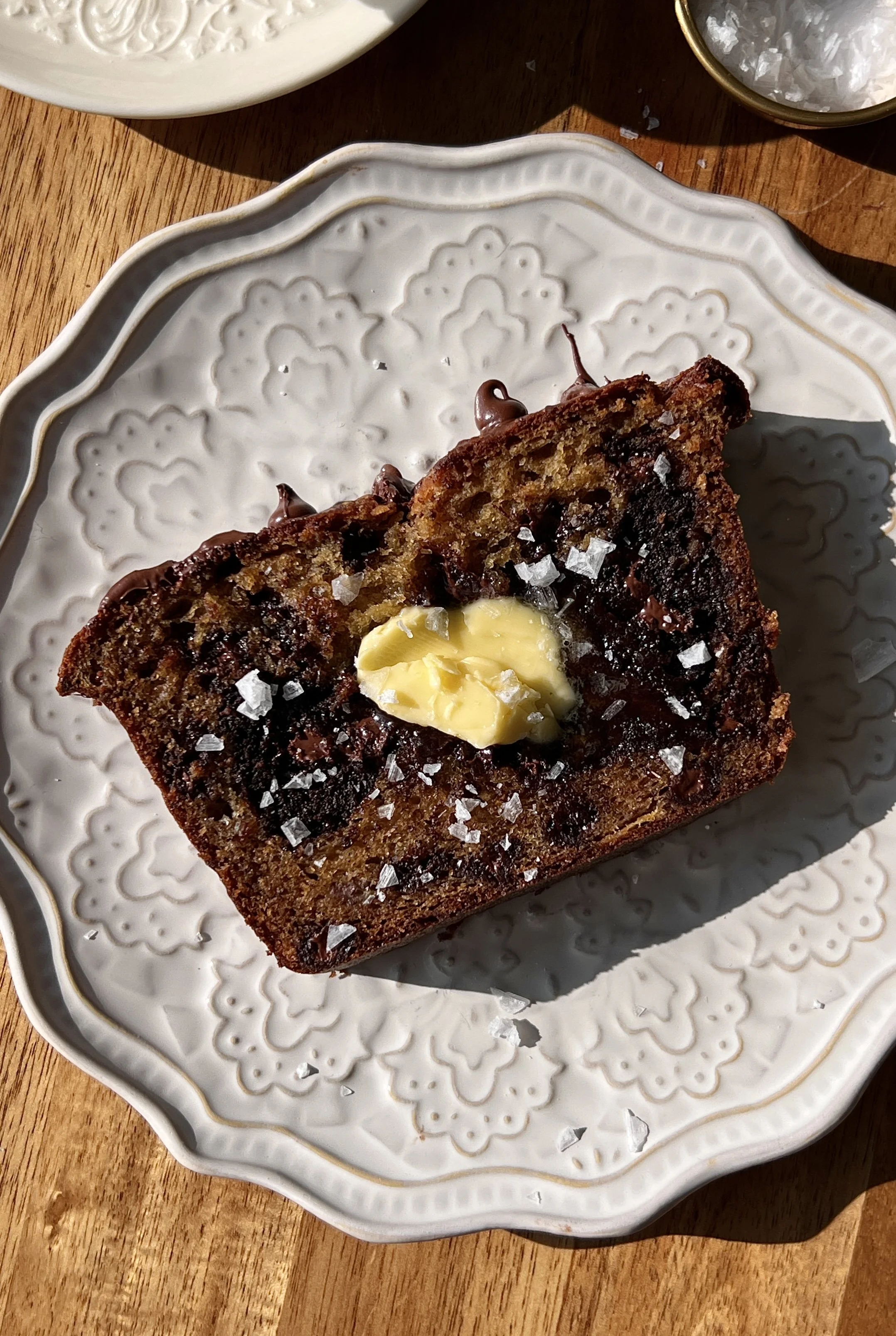 Soft and fluffy brownie stuffed banana bread with brown butter and a beautifully golden exterior served warm with a pat of butter, a sprinkle of flaky sea salt, and a hot cup of coffee.