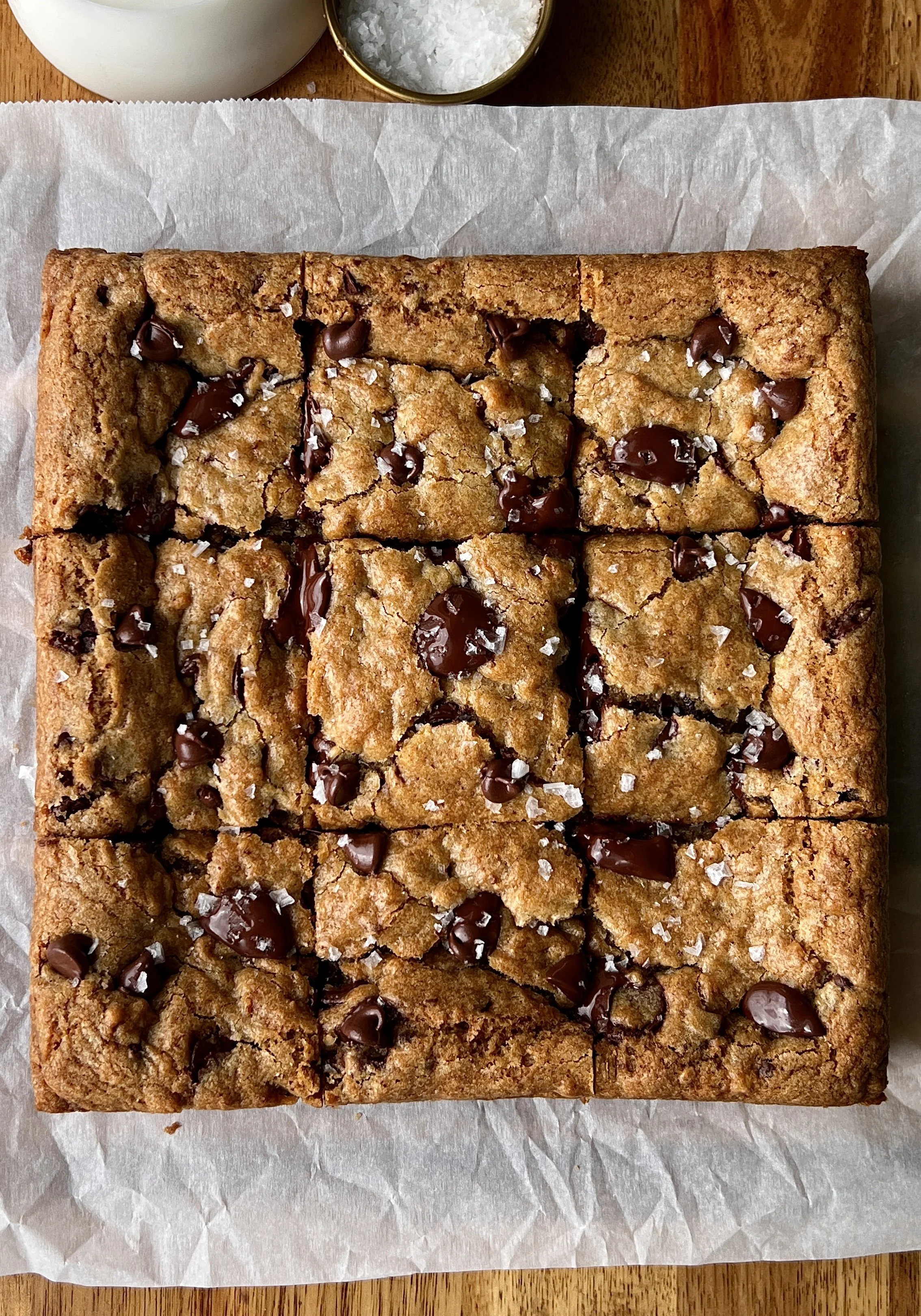 Close-up of a brown butter banana bread chocolate chip cookie bar showing the soft and gooey center with melty chocolate chips throughout and perfectly crisp and golden edges.
