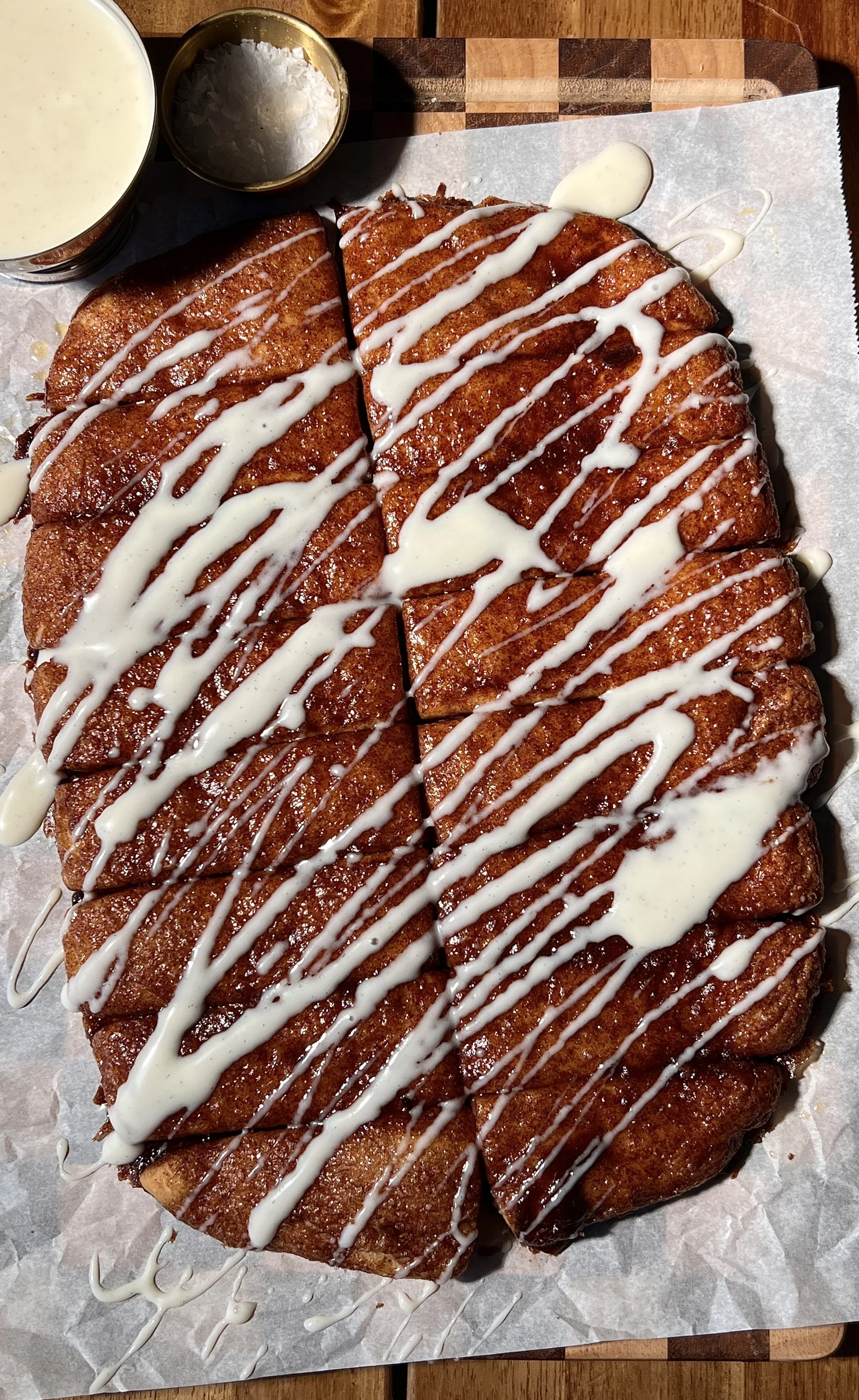 Soft and fluffy sourdough cinnasticks made with sourdough discard and Greek yogurt dough, topped with gooey cinnamon sugar and drizzled with a tangy cream cheese glaze, served warm.