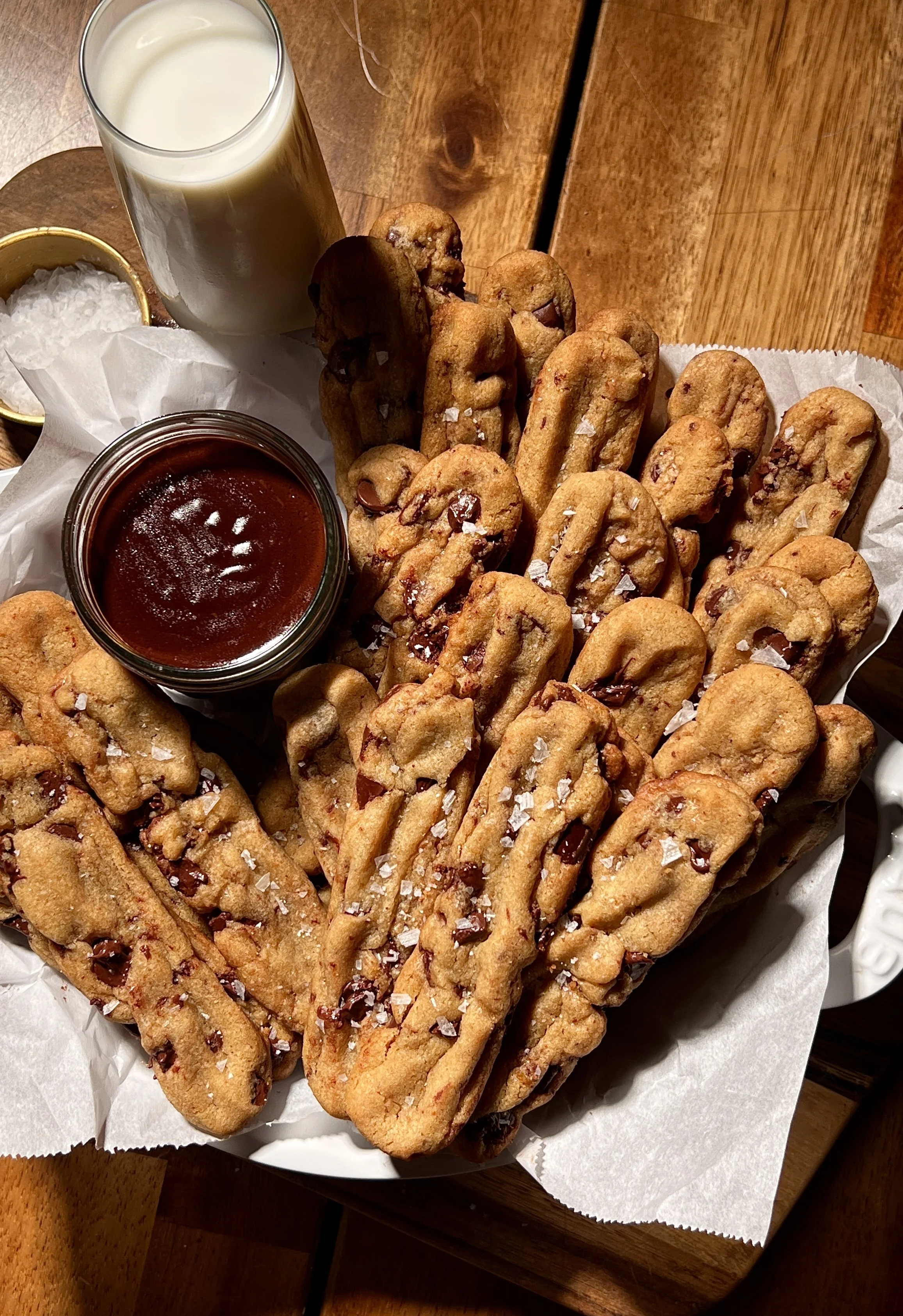 Brown butter chocolate chip cookie fries with crisp edges and melty chocolate chips, served warm with hot fudge sauce and flaky sea salt.