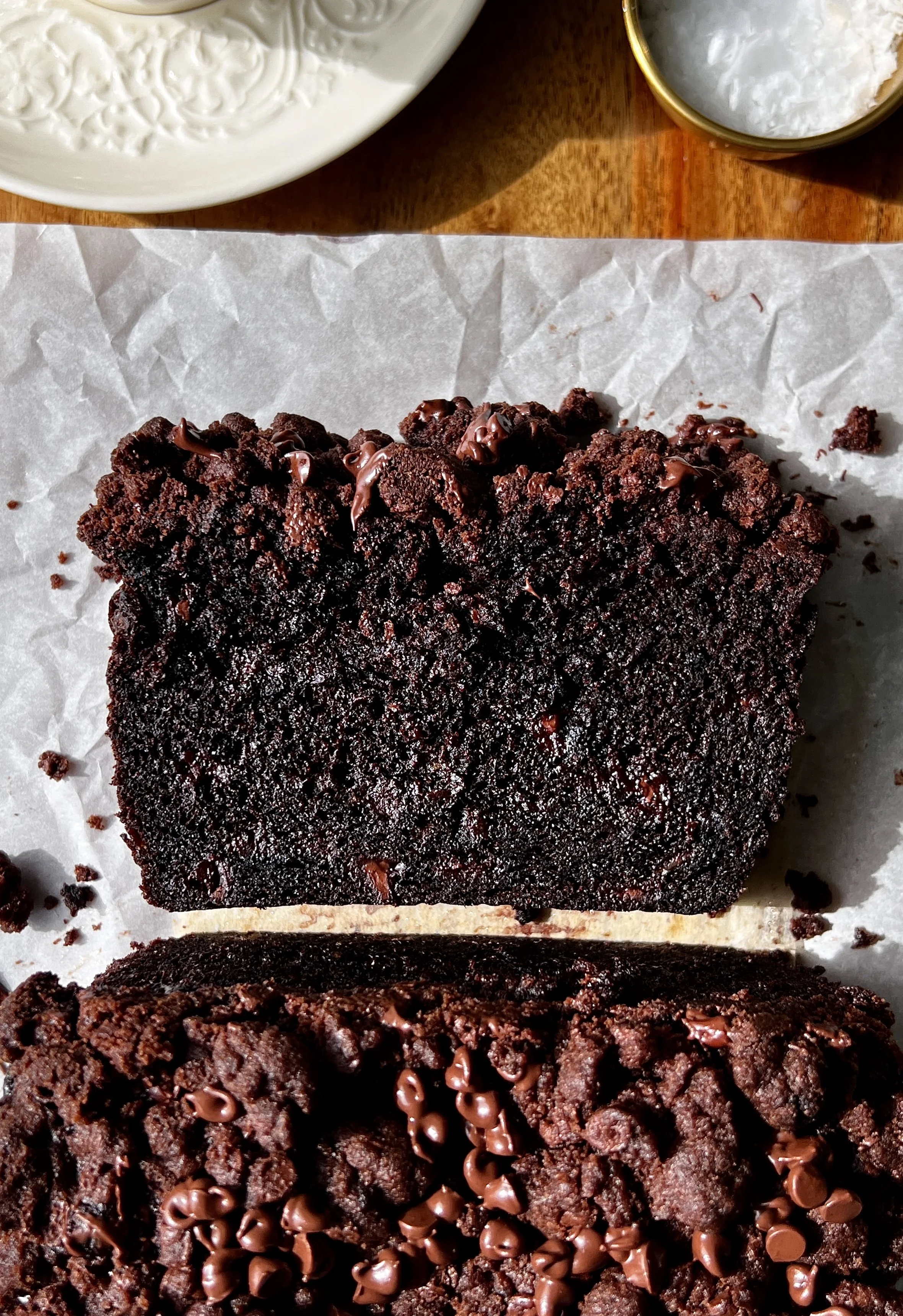 Double chocolate crumb banana bread with brown butter and a chocolate chip chocolate crumb topping served warm with a pat of butter and flaky sea salt.