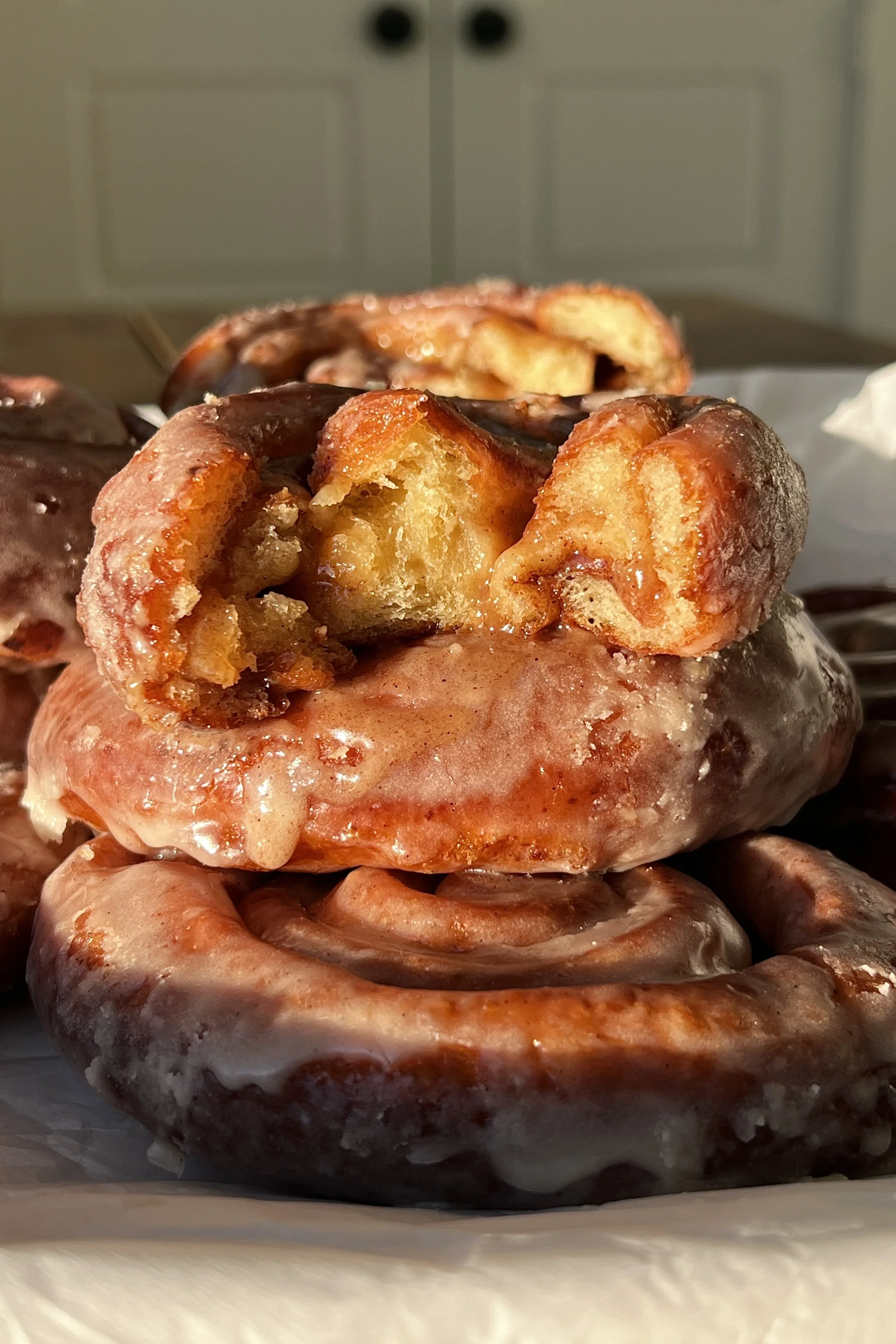 Close-up of a homemade honey bun showing gooey honey butter cinnamon swirl and tender interior.