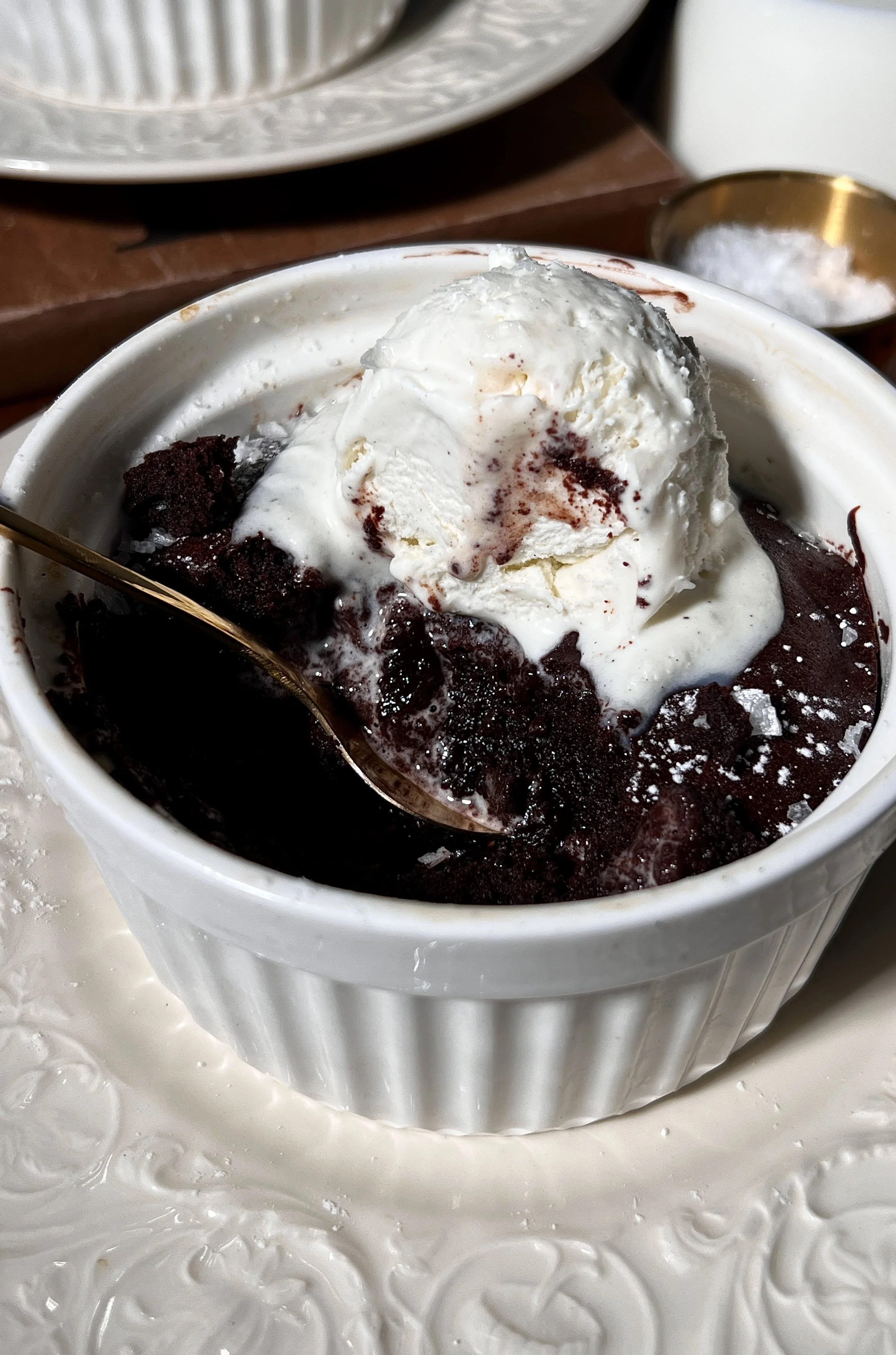Close-up of flourless chocolate cake showing a fudgy interior and crackly chocolate top.