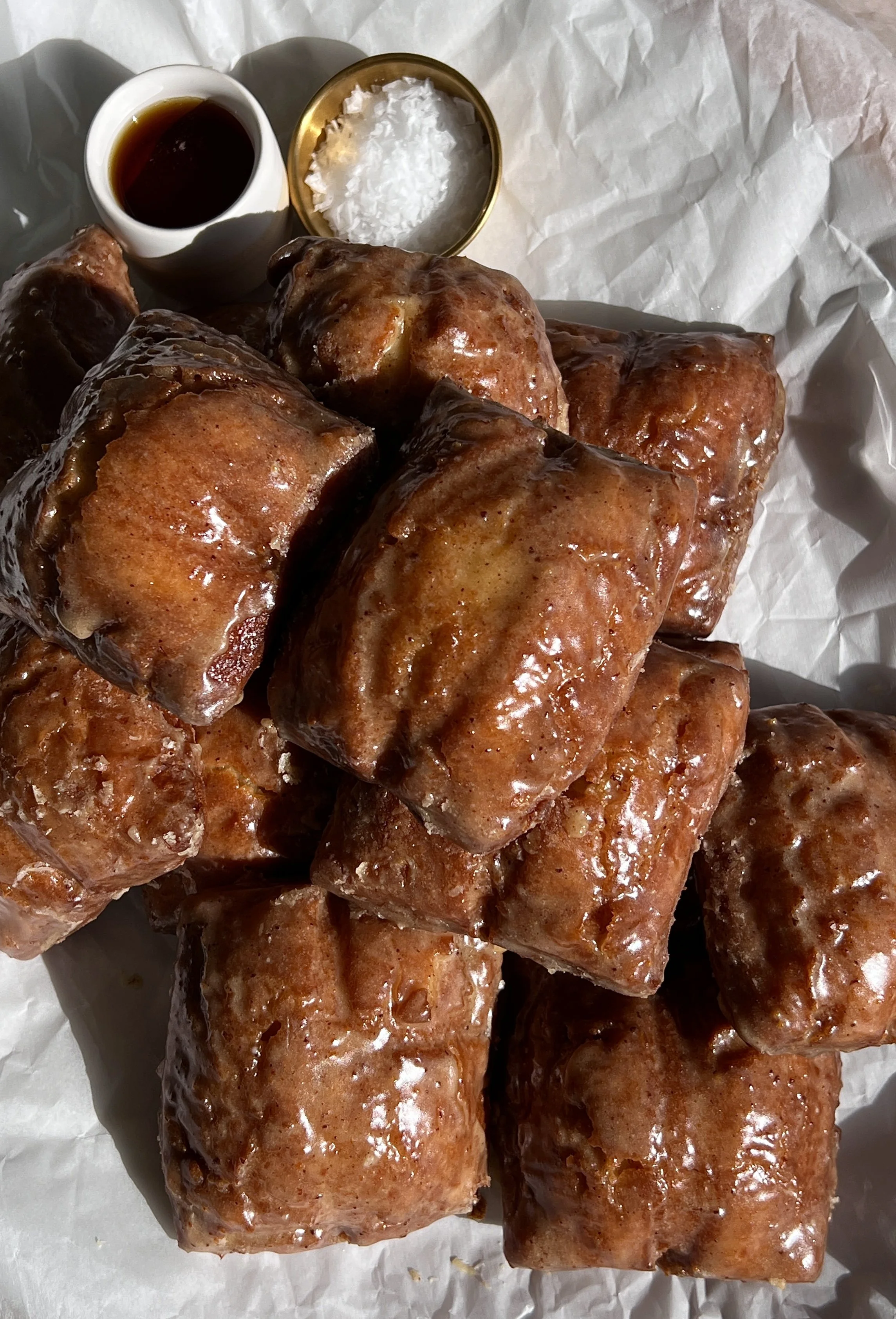 Old-fashioned buttermilk donut bars glazed with brown butter maple vanilla bean icing.