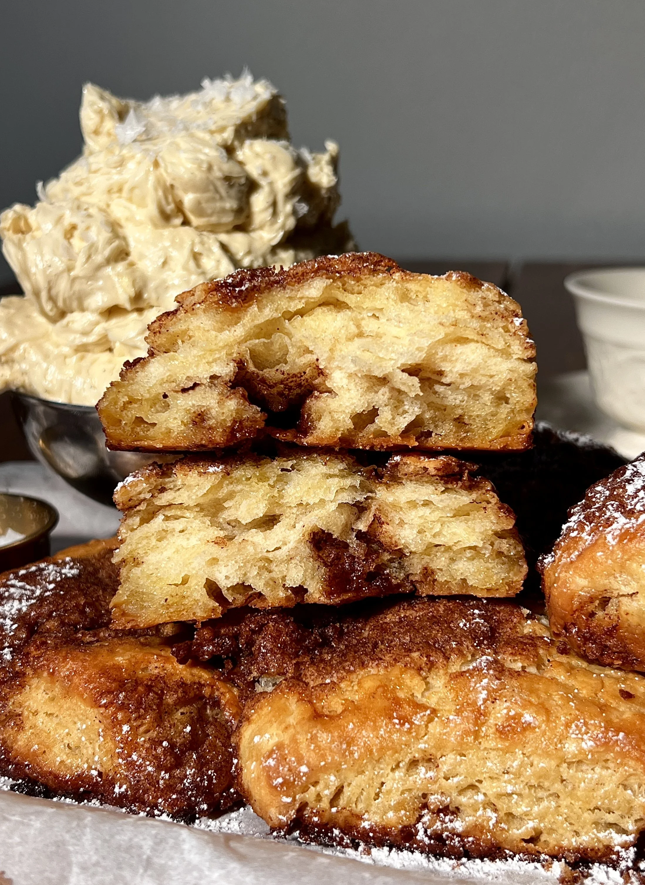 Close-up of flaky French toast biscuits showing buttery layers and cinnamon sugar swirls.