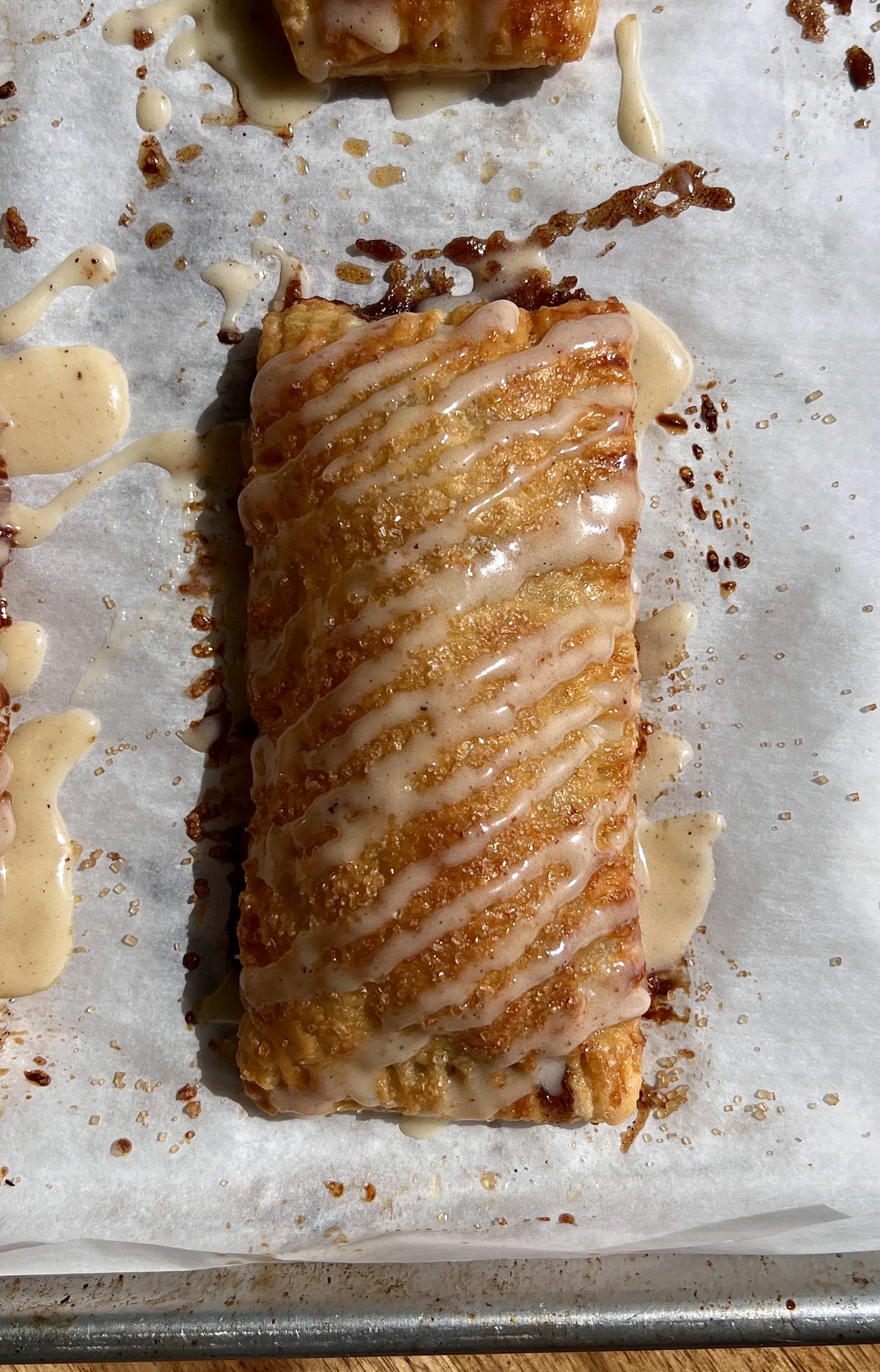 Homemade cinnamon roll toaster strudels made with flaky puff pastry and topped with brown butter maple cream cheese glaze.