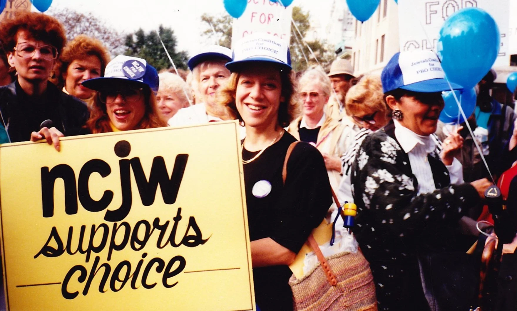 Vintage photo of a group of women holding a sign that says "NCJW supports choice"