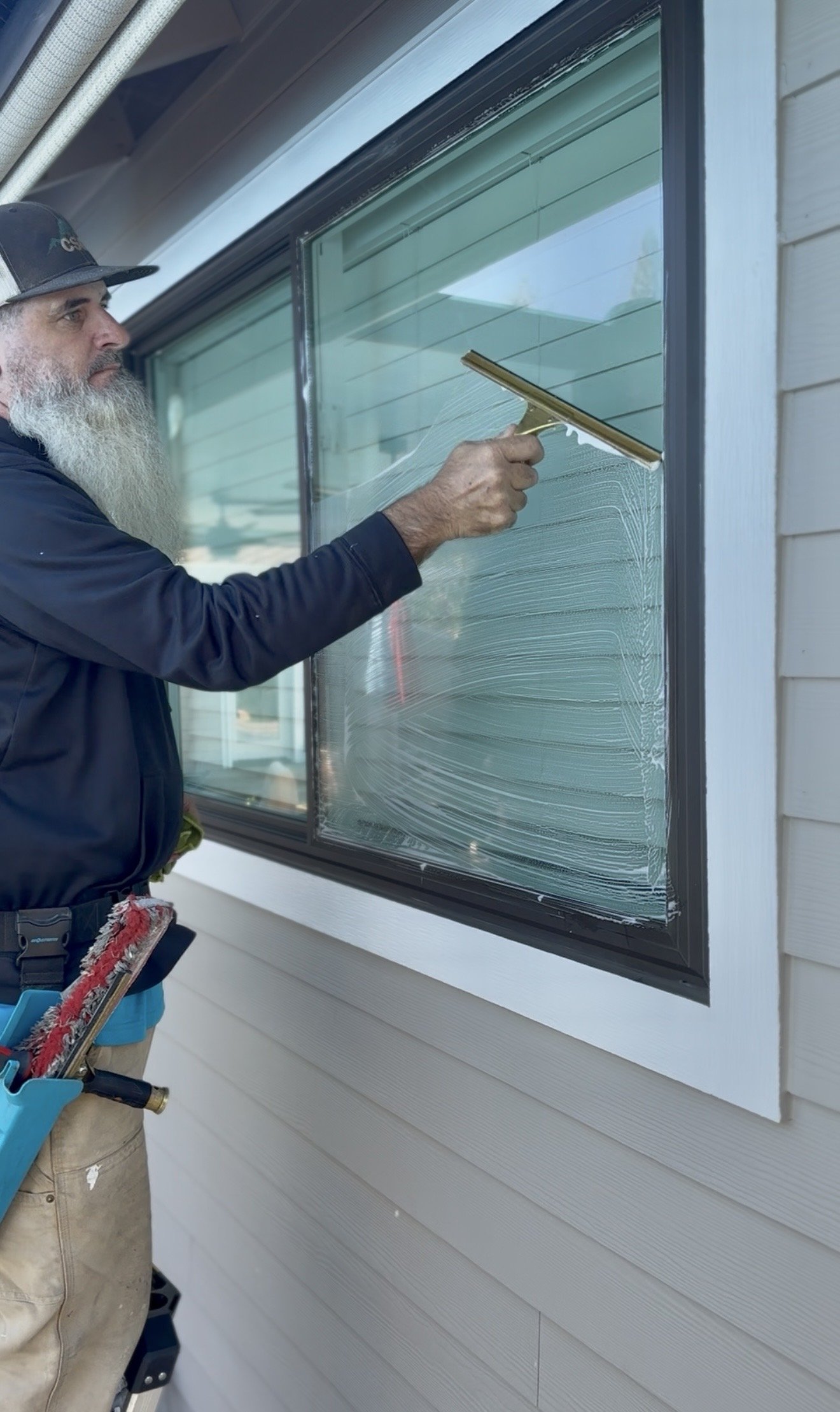 CSG professional using specialized equipment for streak-free window cleaning in Sacramento