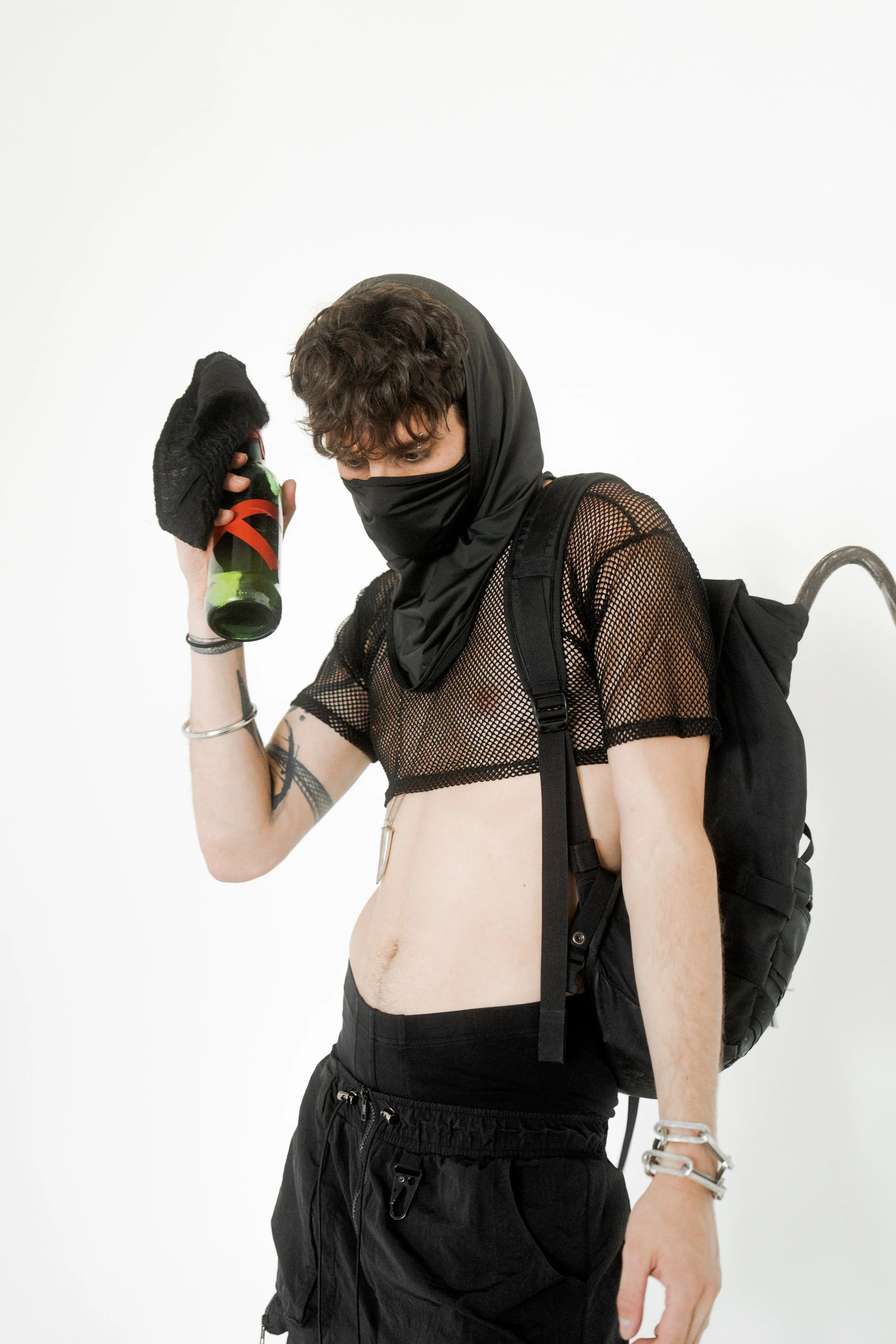 XINIX wearing black avant garde outfit with mask holding object dark futuristic fashion aesthetic
