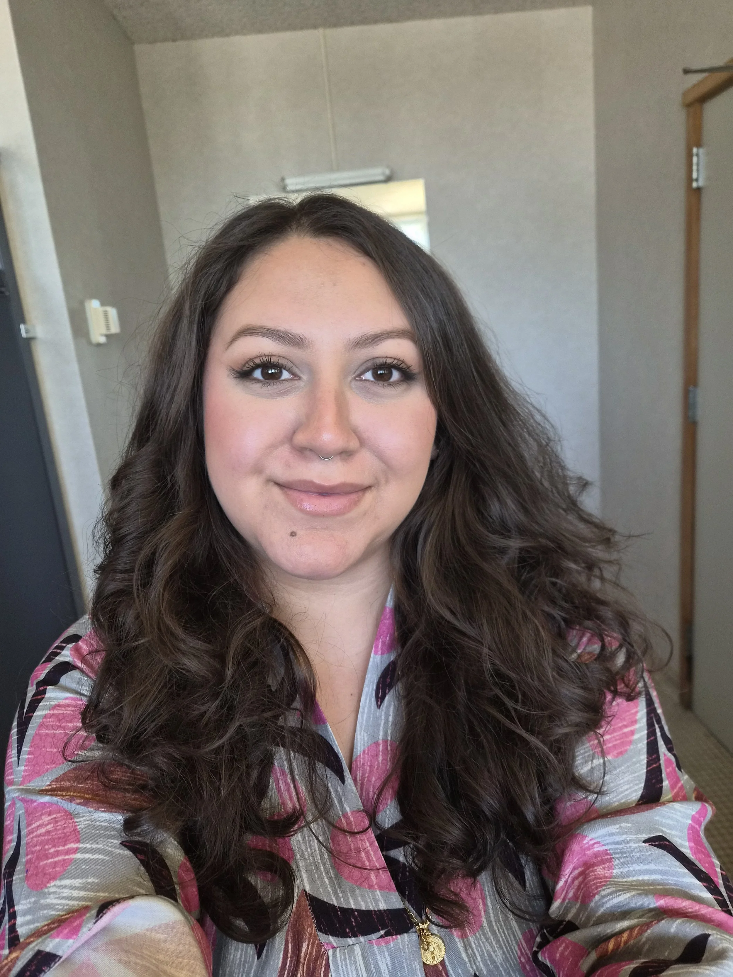 Brunette haired woman smiling warmly into the camera