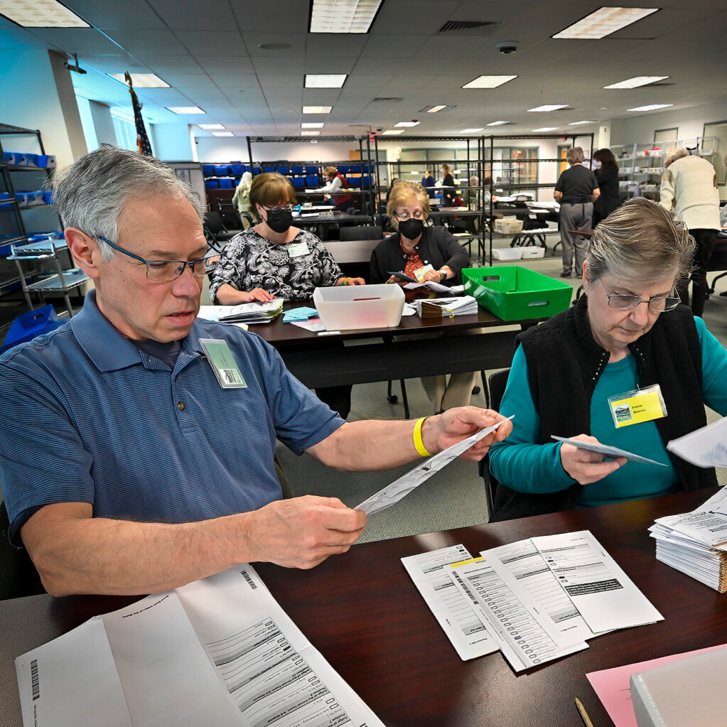 Election workers John Jorgensen and Irene Morris inspect ballots on May 16, 2022 at the Marion County Clerk’s Office in Salem. In future elections, Oregon might opt for ranked choice voting. (Photo by Ron Cooper/Oregon Capital Chronicle)