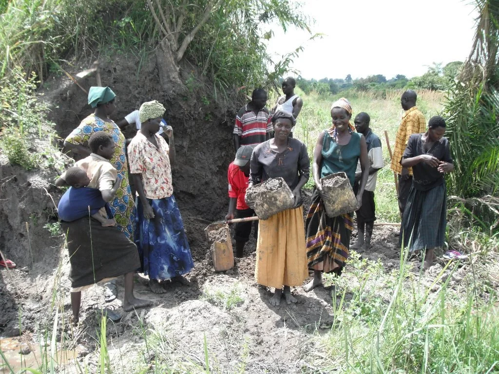 collecting ant hill clay.JPG