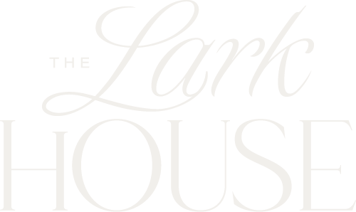 Text that reads 'The Lark House' in elegant white font on a black background.