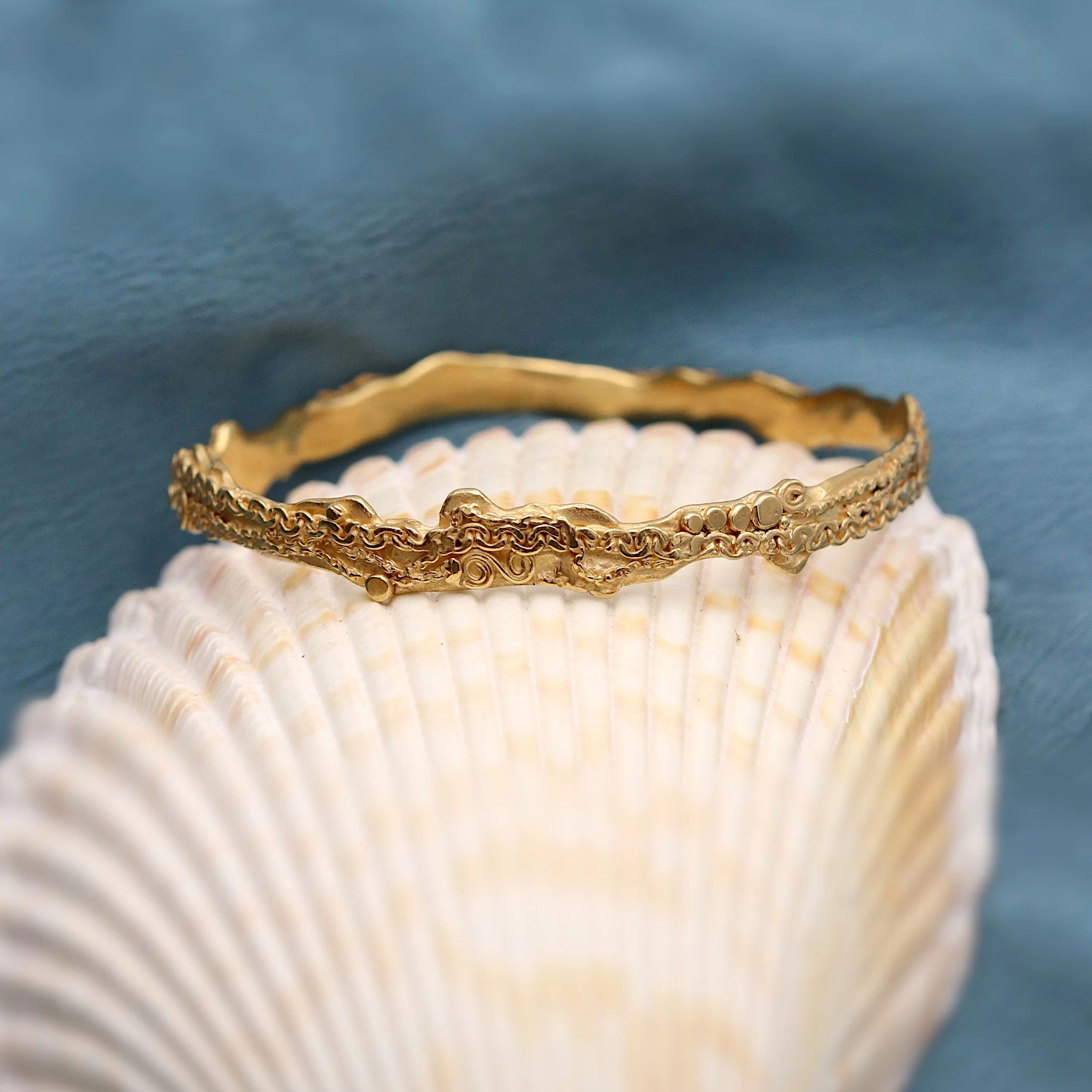 Georgina Hopkin Gold Molten Chain Banngle on shell.jpg