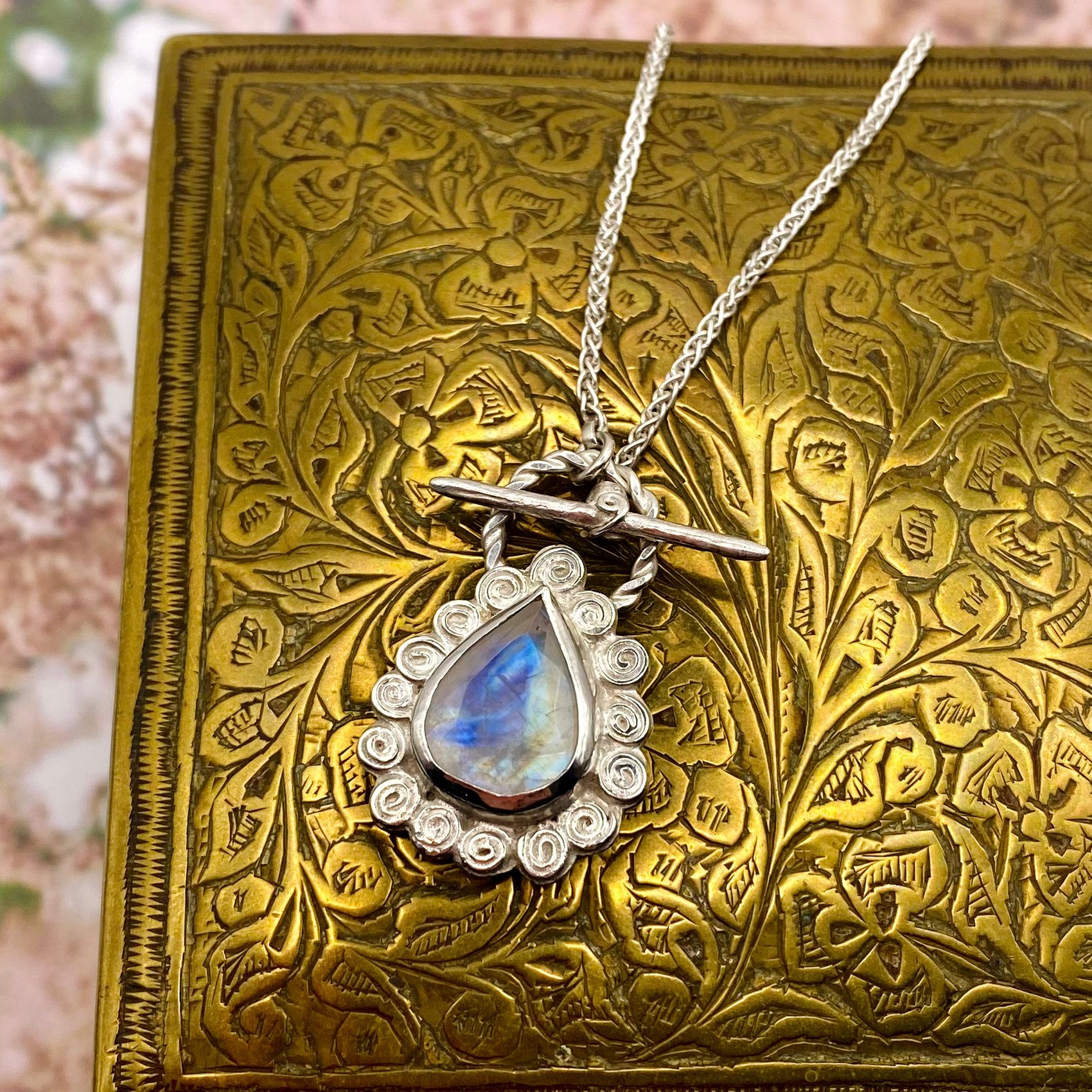 Large Pear Rainbow Moonstone Swirly Halo Pendant on box crop.jpg