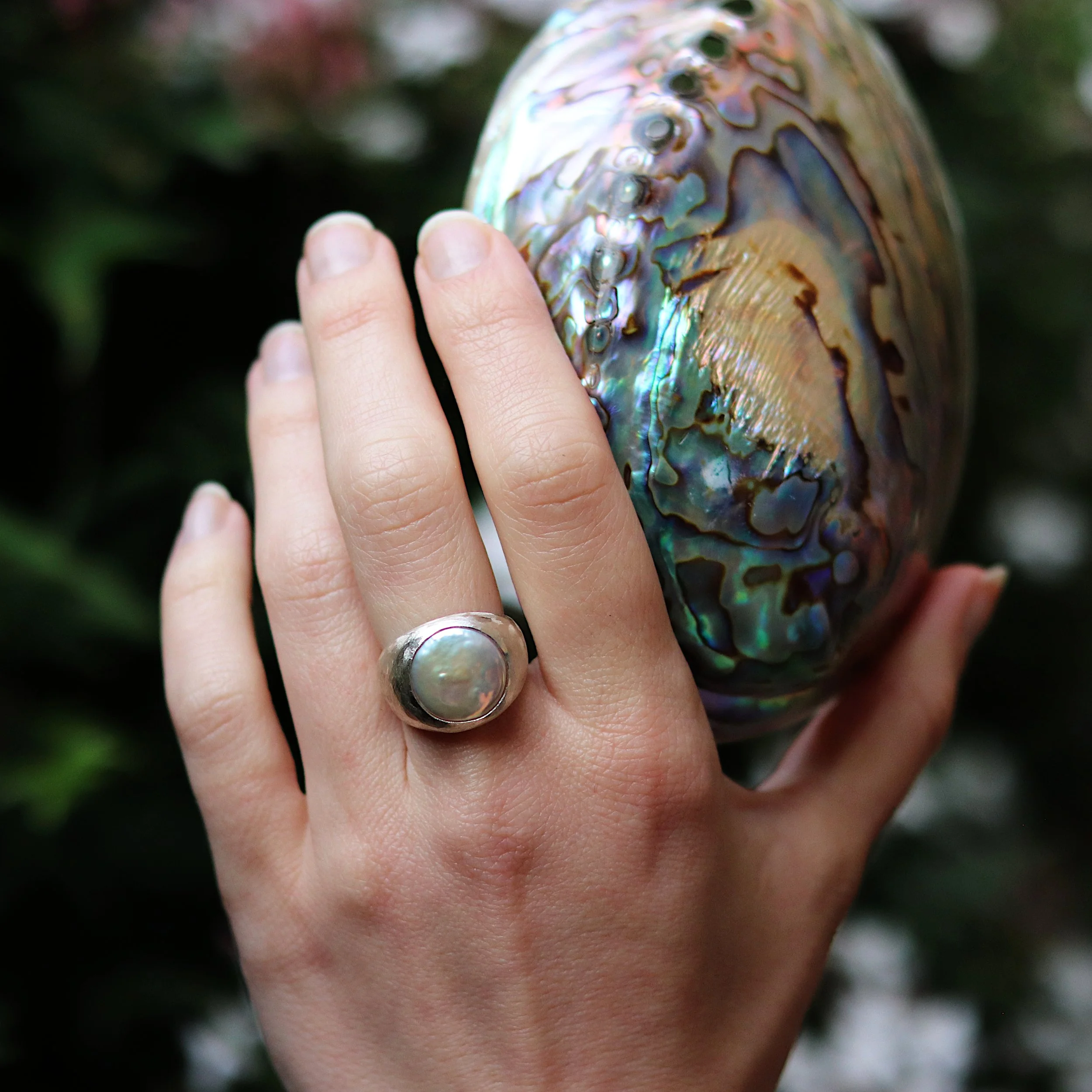 metallic silver pearl signet ring on hand with shell.jpg