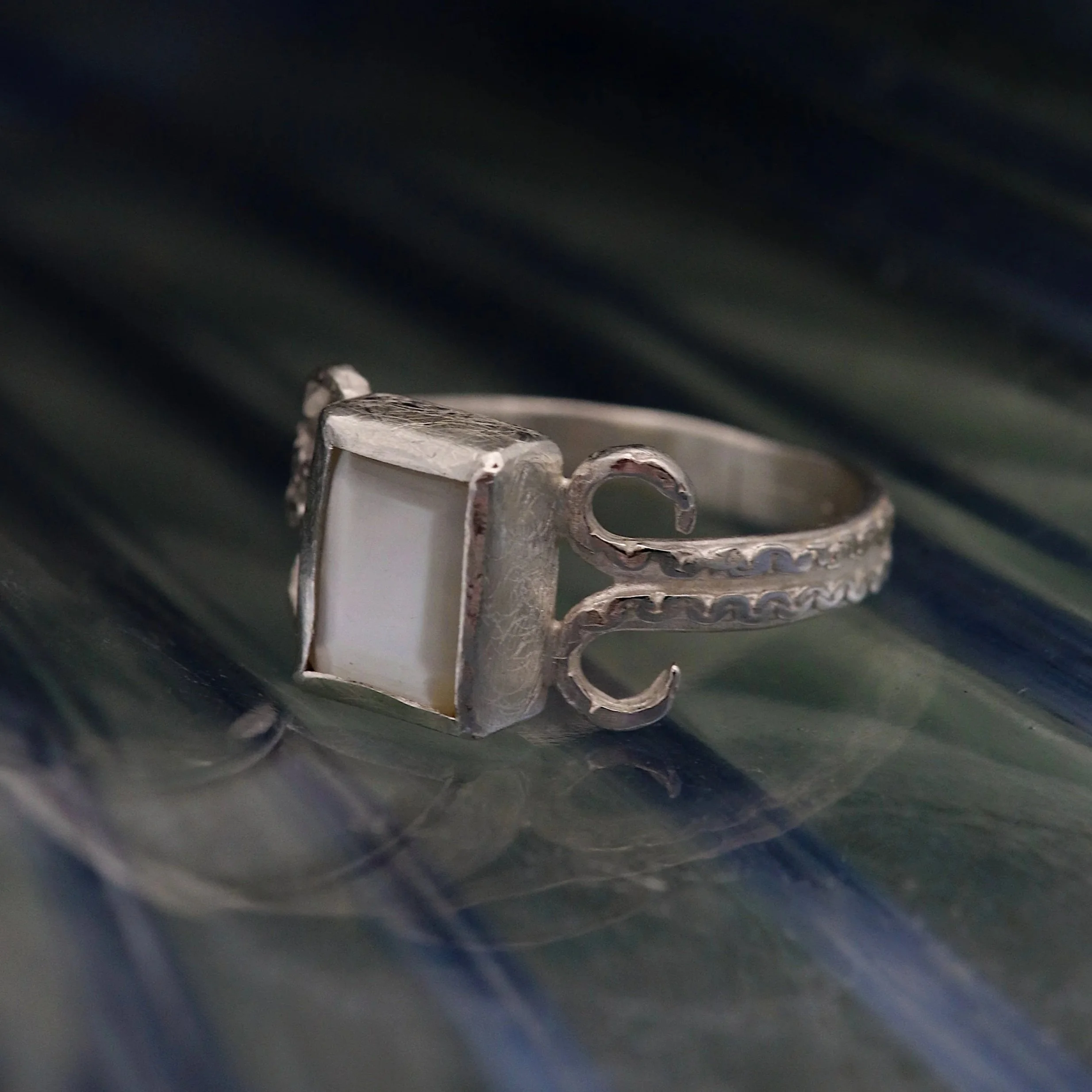 Faceted+Mother+Of+Pearl+Coiled+Silver+Ring+on+glass.jpg