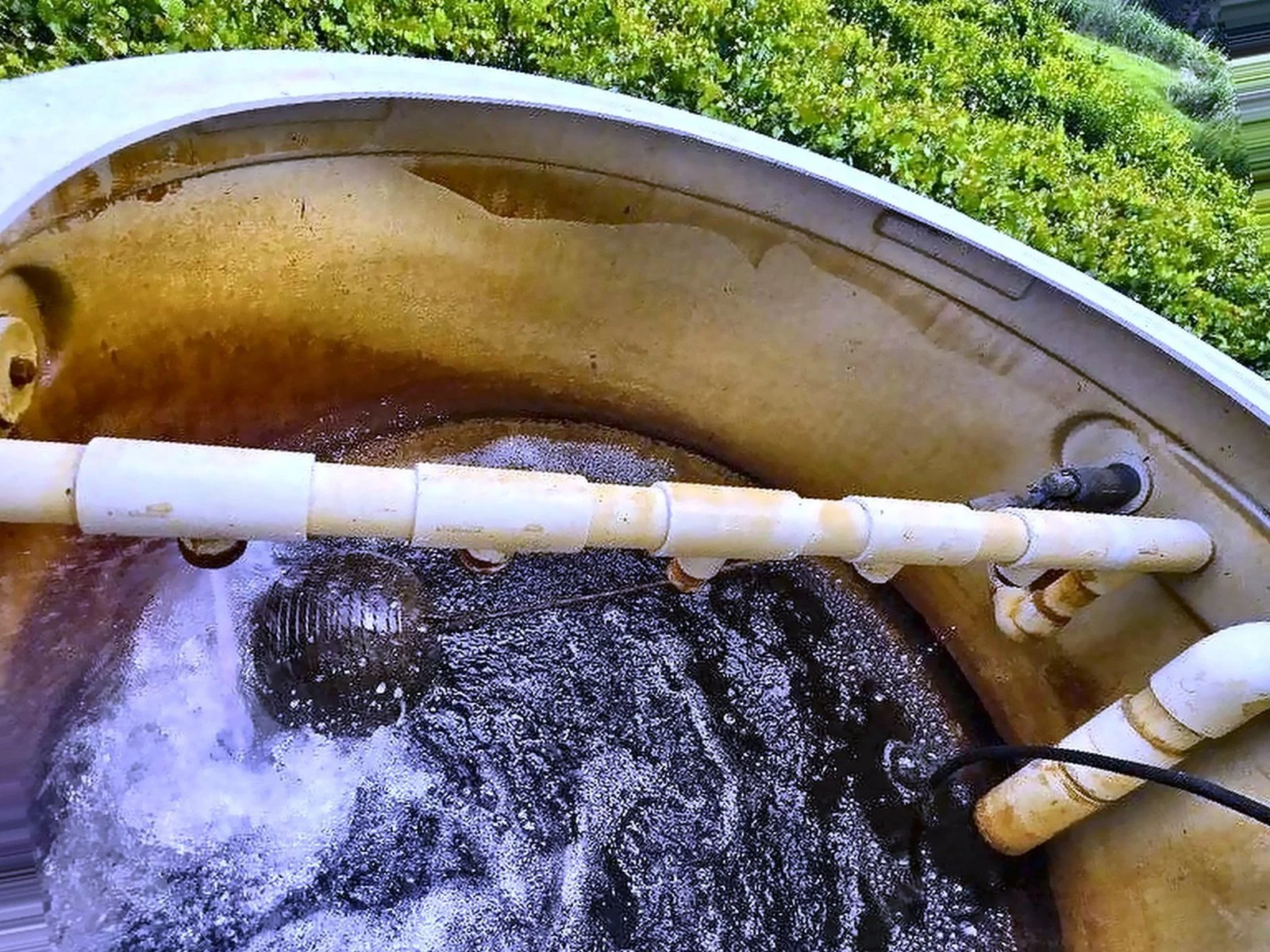Iron-stained aeration tank from a Southwest Florida well, showing why iron filters are needed