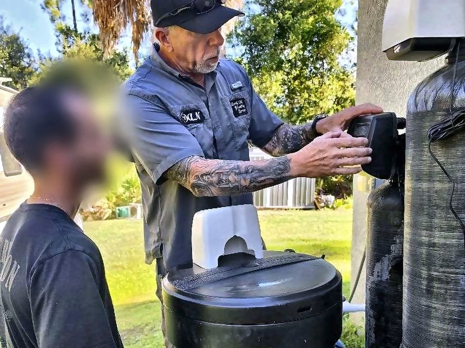 Dan of Good Ole' Plumbing explaining a new water softener to a Cape Coral homeowner
