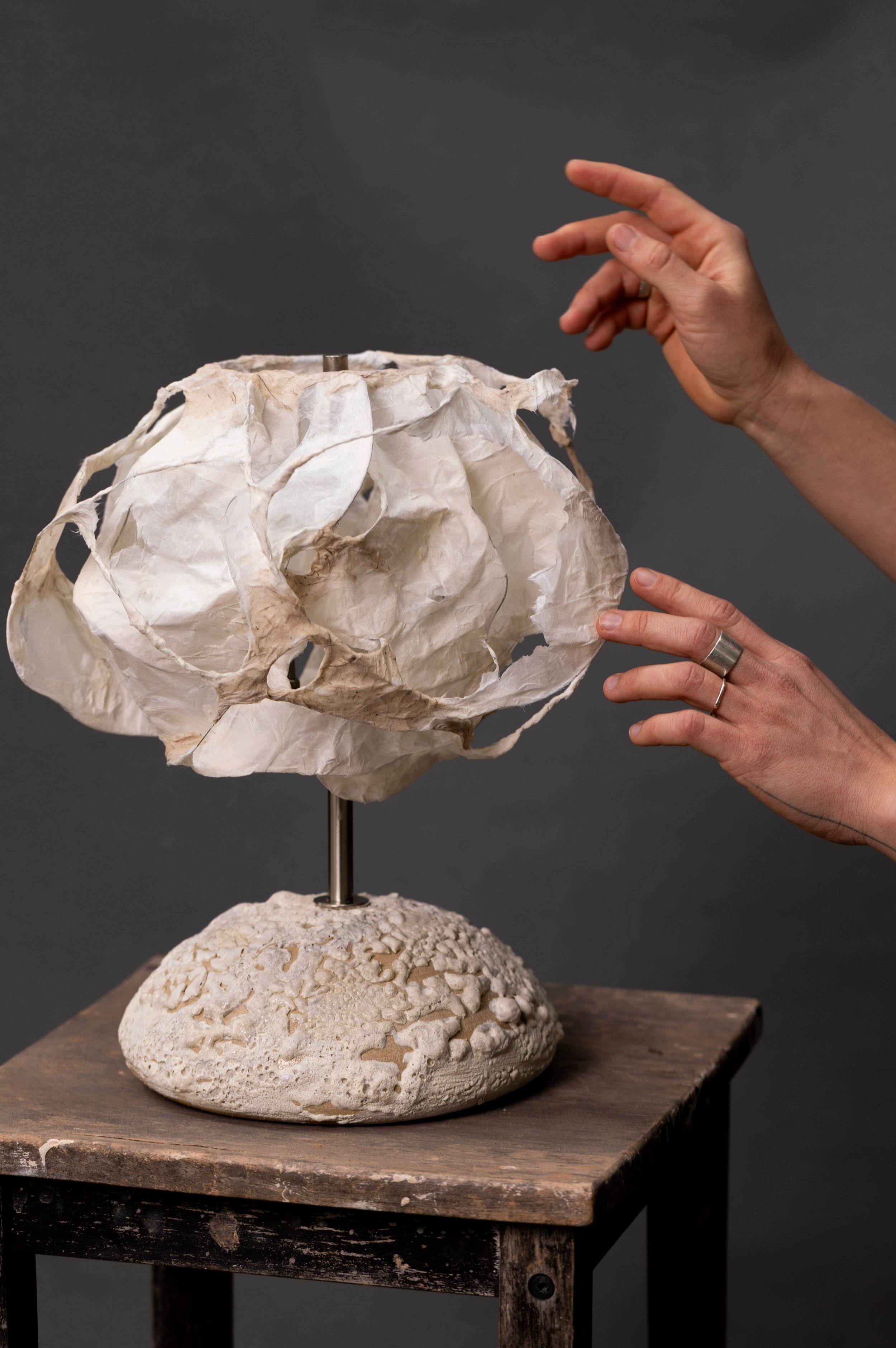 Sculptural ceramic lamp with volcanic crater-glazed base and handmade paper shade — ceramic art by Maria Loram, Loram Ceramics