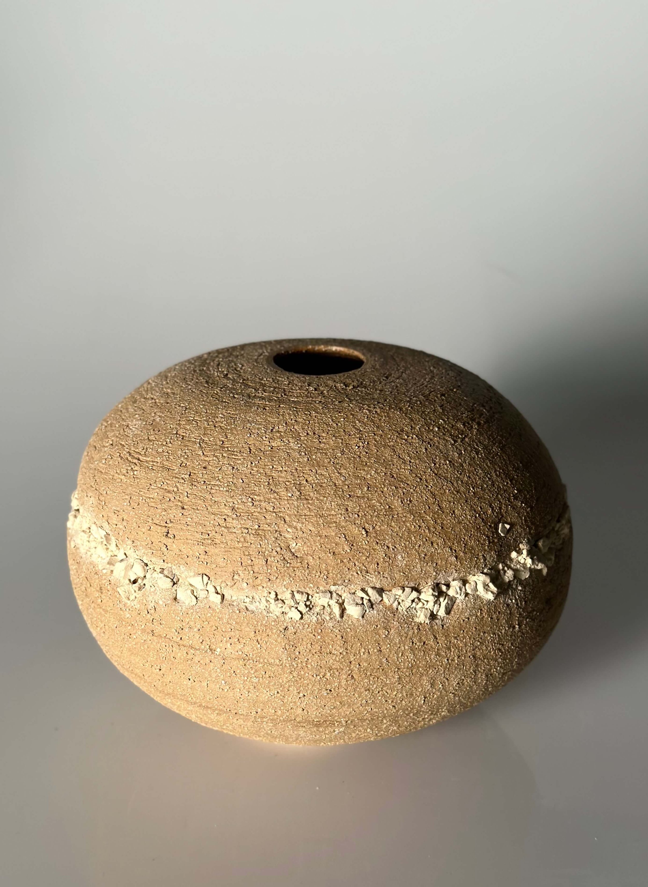 Japandi ceramics, minimalist home decor, hand-thrown ceramics, textured stoneware, medium sculptural vessel, neutral-toned pottery, artisanal homeware for designers, curated minimalist home accents