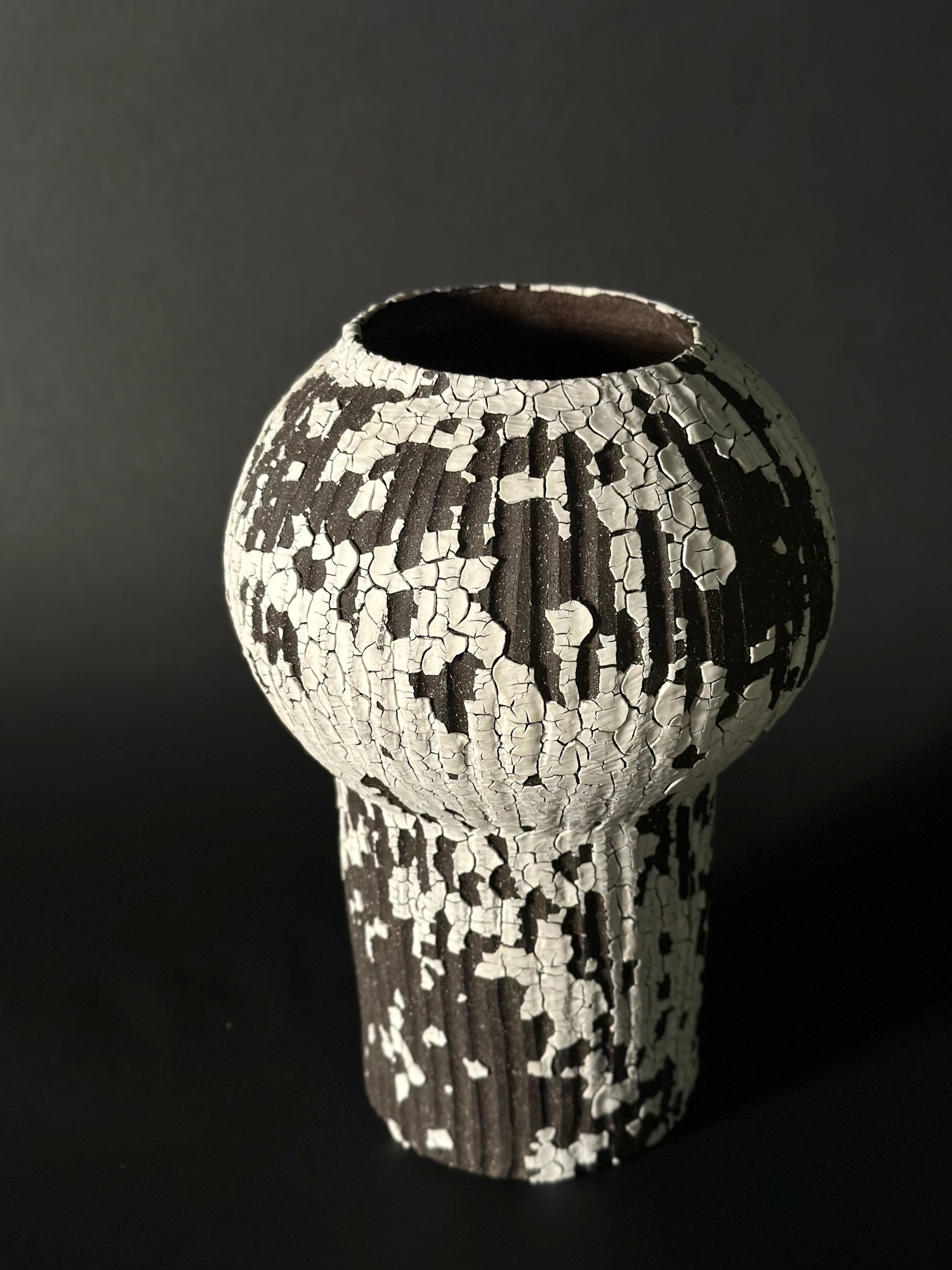 Japandi ceramics, Scandinavian rustic, artisan-made homeware, unglazed stoneware, weathered textures, oversized ceramic centerpiece, deep charcoal black clay, curated minimalist home accents
