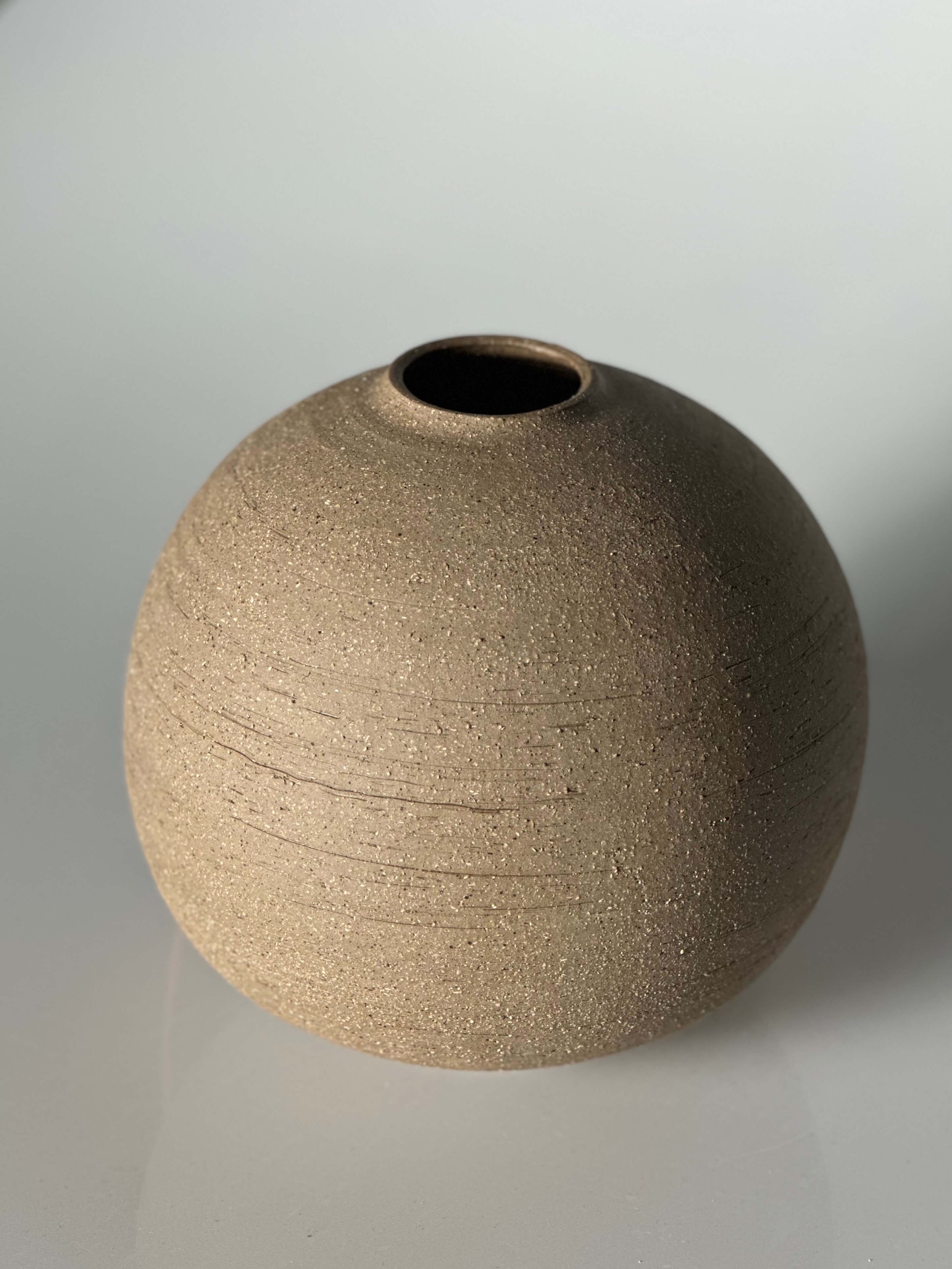 Scandinavian rustic, minimalist home decor, unglazed stoneware, earth-toned pottery, raw clay vase, handcrafted ceramic moon jar, neutral-toned pottery, collectible ceramics for designers