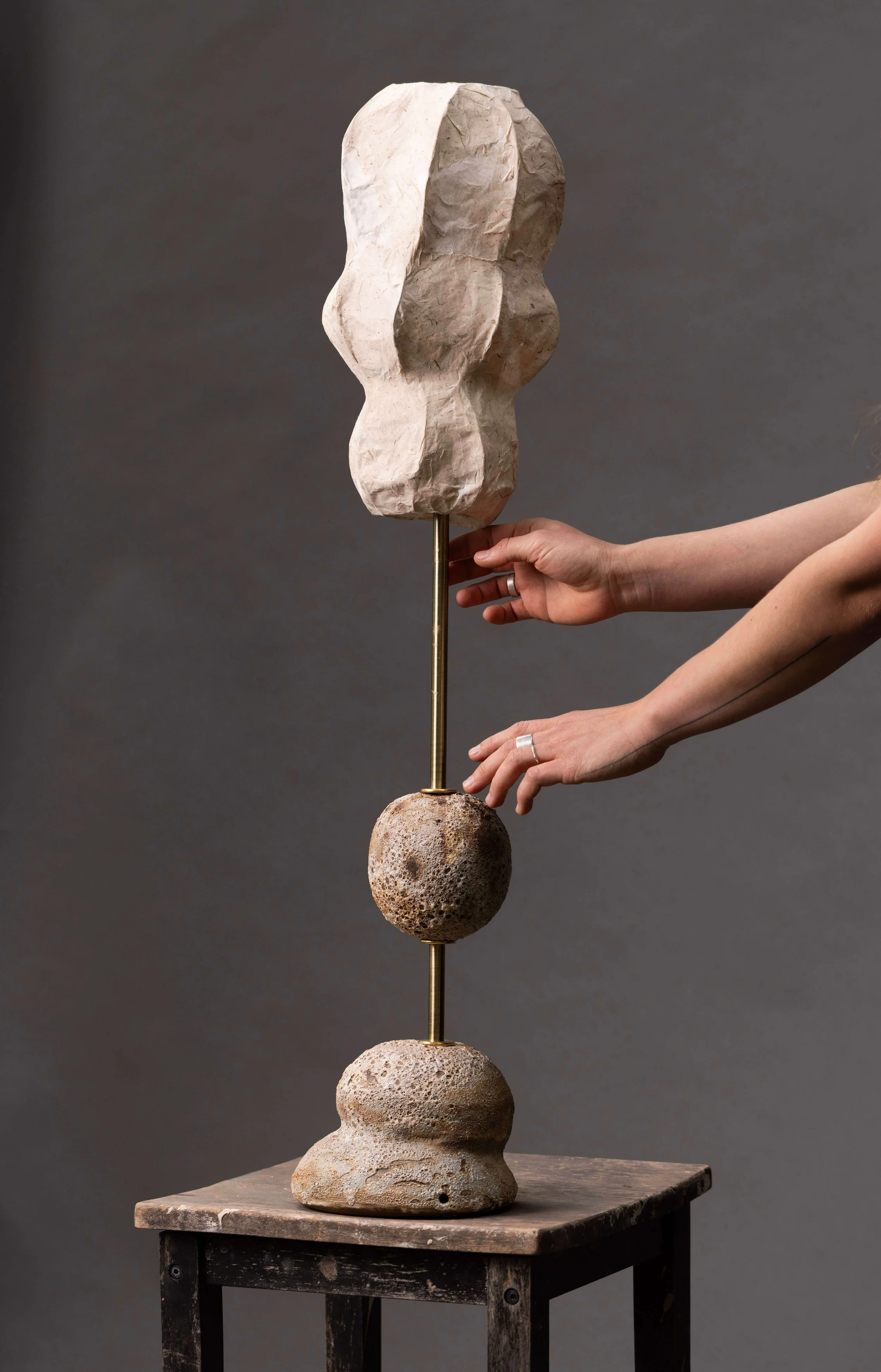 Tall sculptural lamp, two stacked lava-glazed elements on brass rod, abstract paper shade