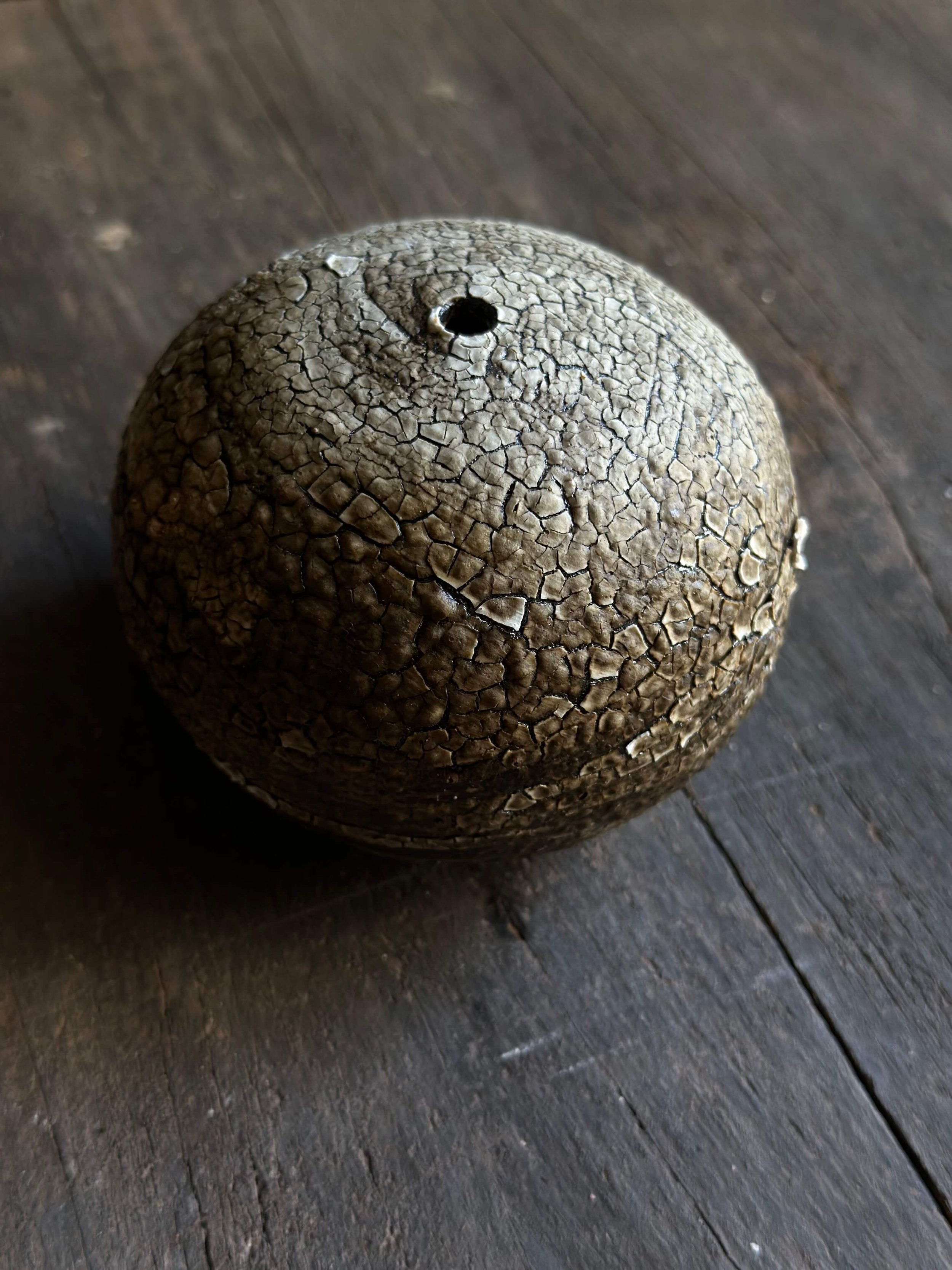 Dark olive/brown vessel with crawl/crackle glaze like dried earth