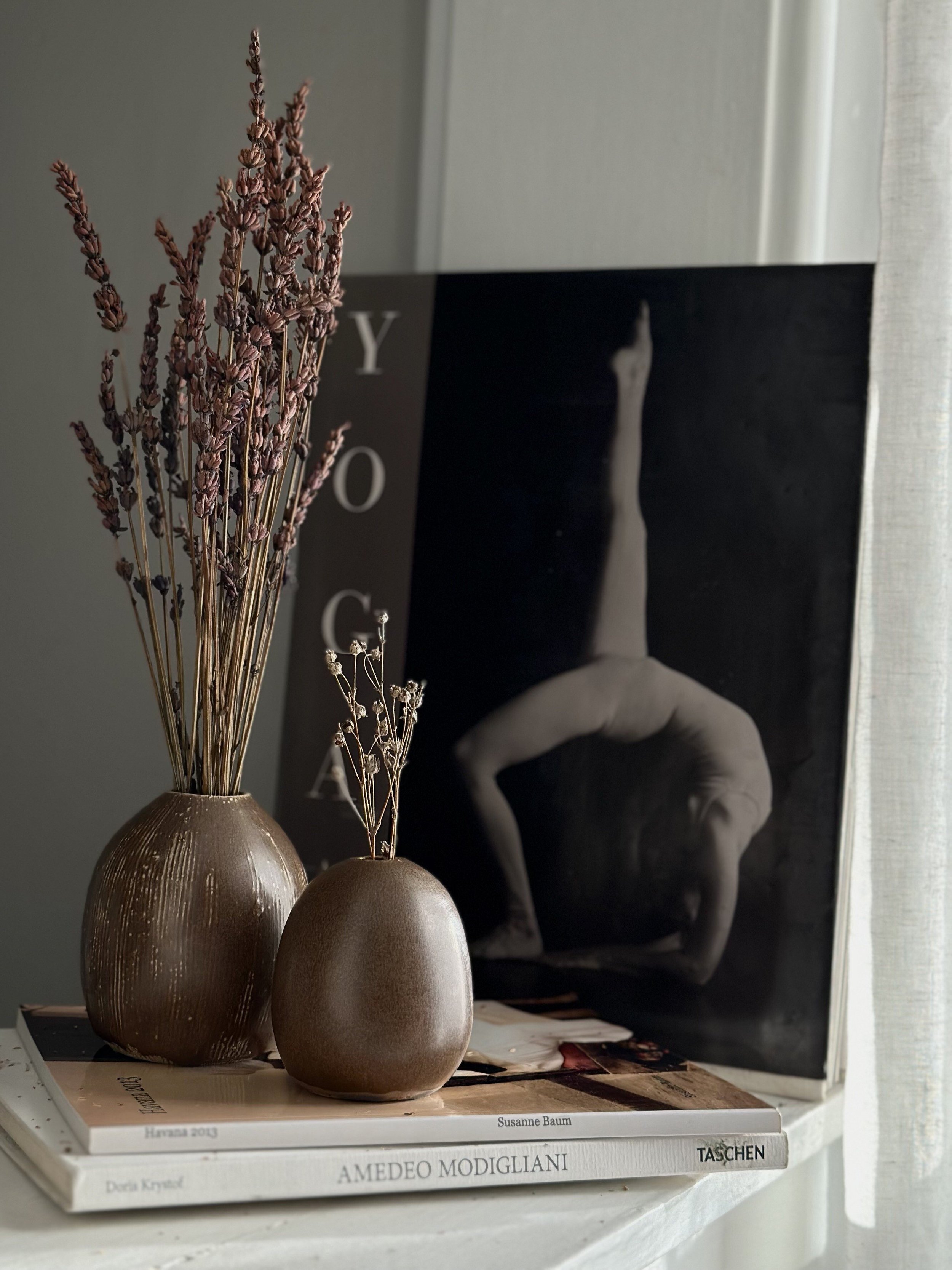 The serene beauty of our minimalist small bud vases, with their organic texture and handcrafted appeal, embodies the wabi-sabi philosophy, ideal for any single-stem floral arrangement.