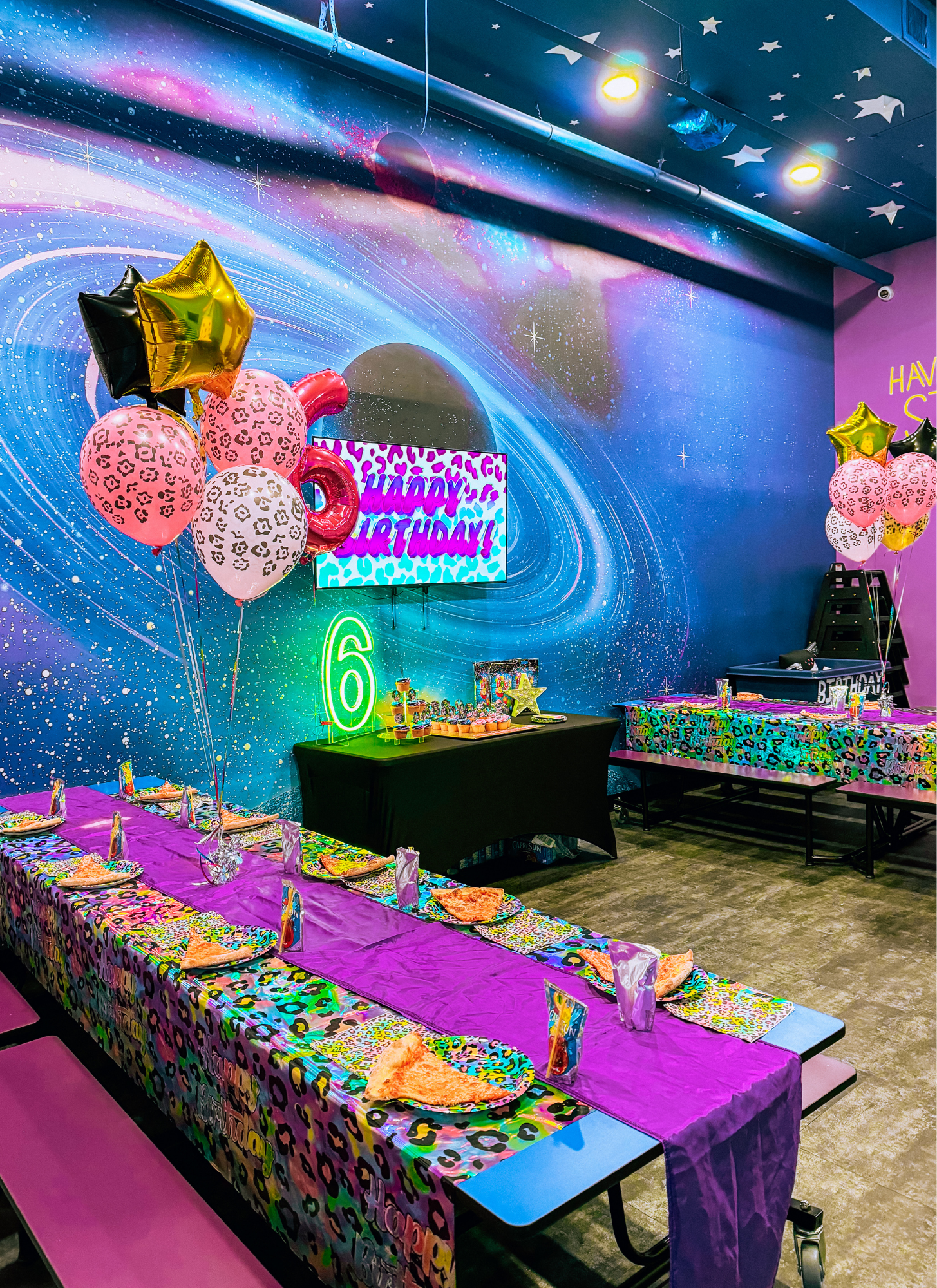 Themed birthday party room setup with decorations and balloons at Planet Play Bellmore.