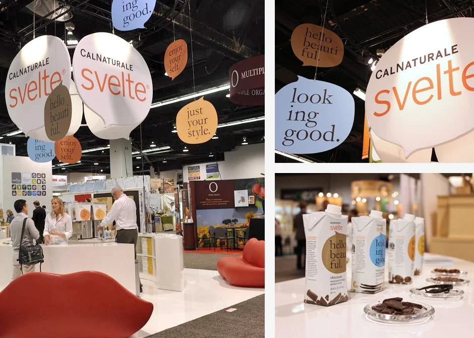 Trade show booth for CALNATURALE Svelte with hanging signs that say Hello beautiful, enjoy yourself, just your style, looking good.