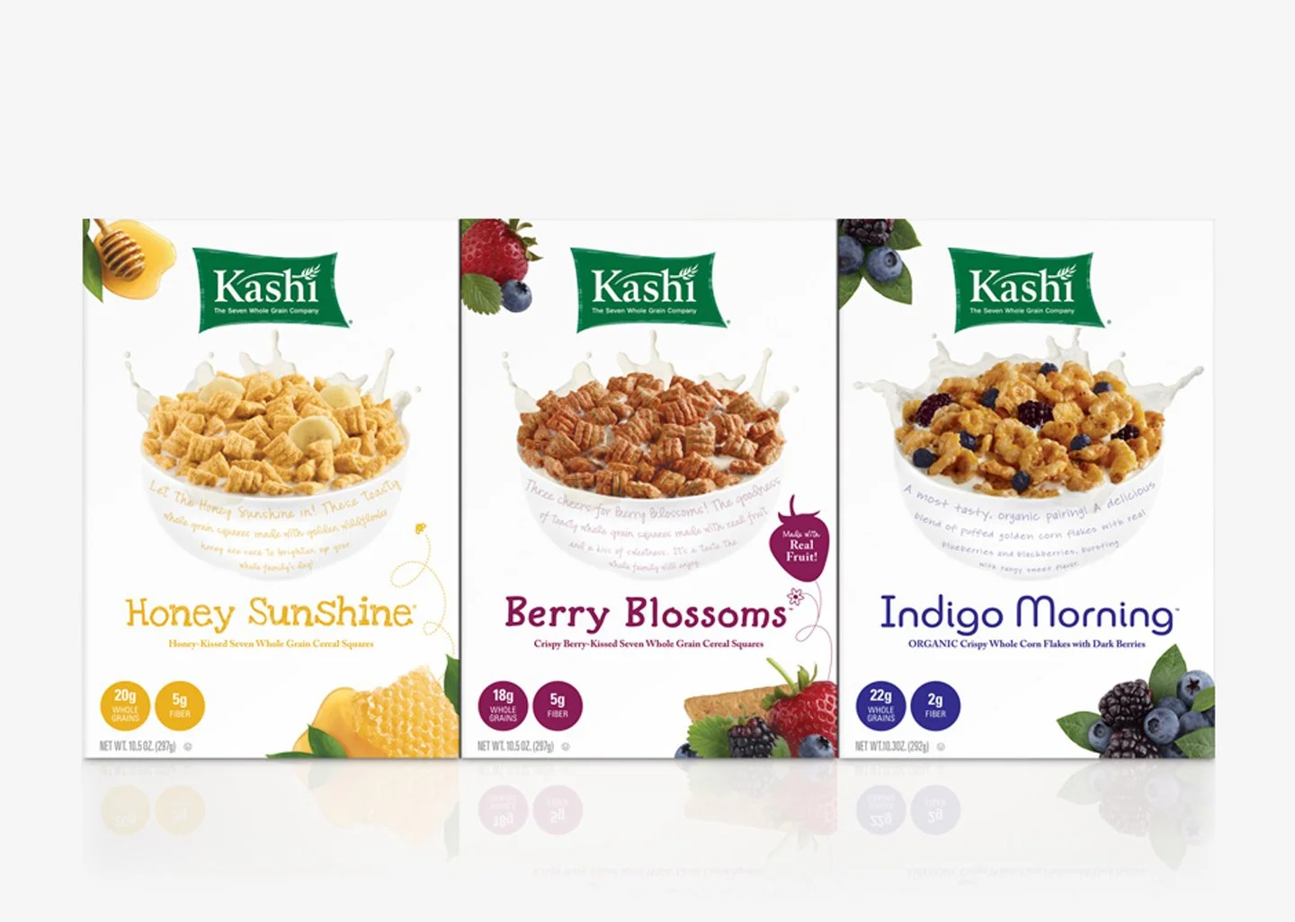 Three cereal boxes from Kashi featuring Honey Sunshine, Berry Blossoms, and Indigo Morning flavors, with images of the respective fruits on each box.