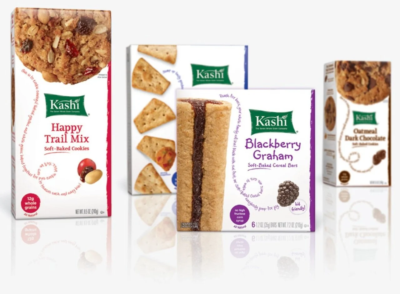 Four boxes of Kashi cereal and snacks including Happy Trail Mix Cookies, Blackberry Graham cereal bars, Oatmeal Dark Chocolate cookies, and a snack with pictorial crackers.