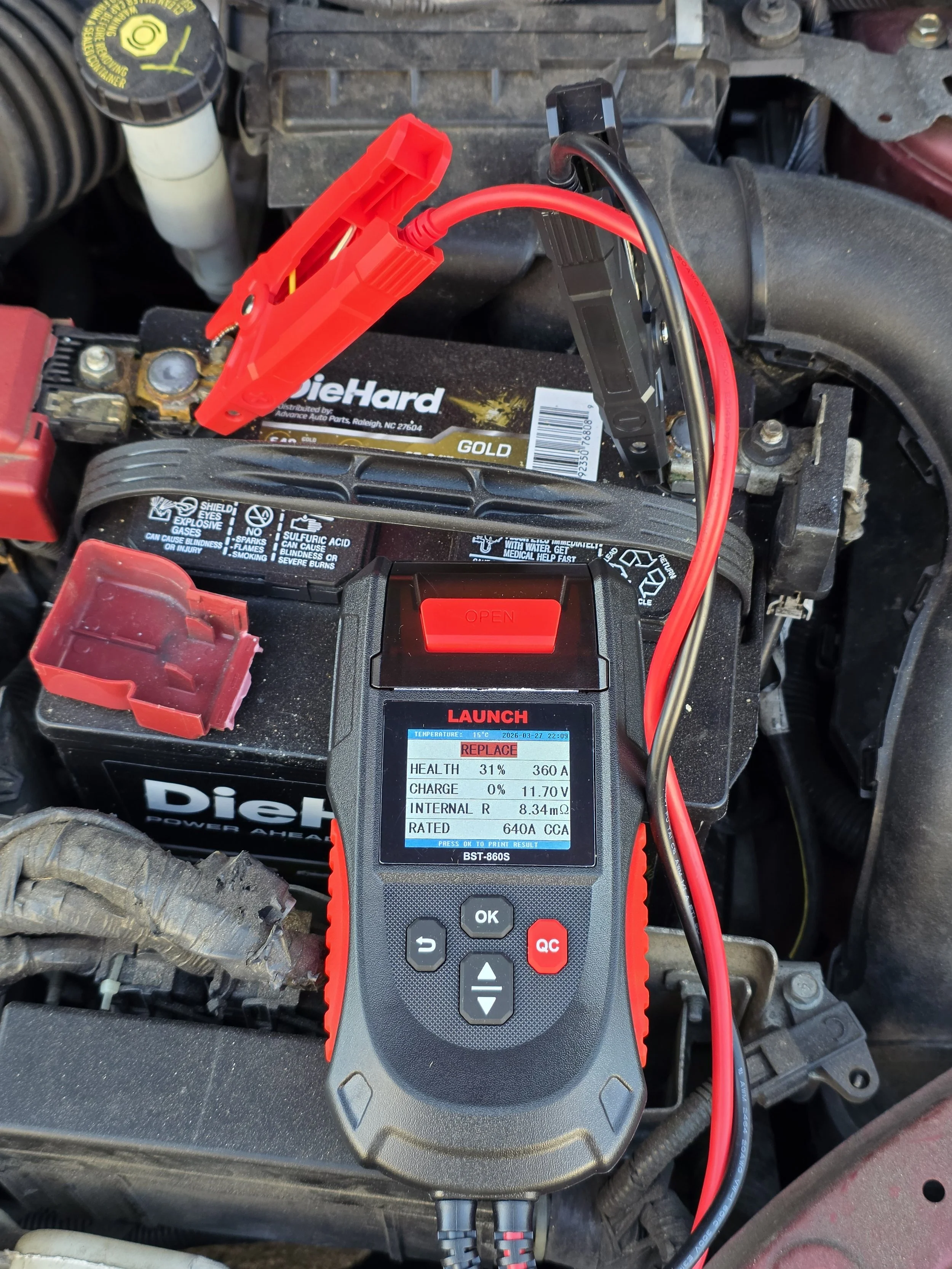 A digital battery tester connected to a car battery showing a health percentage of 31%.