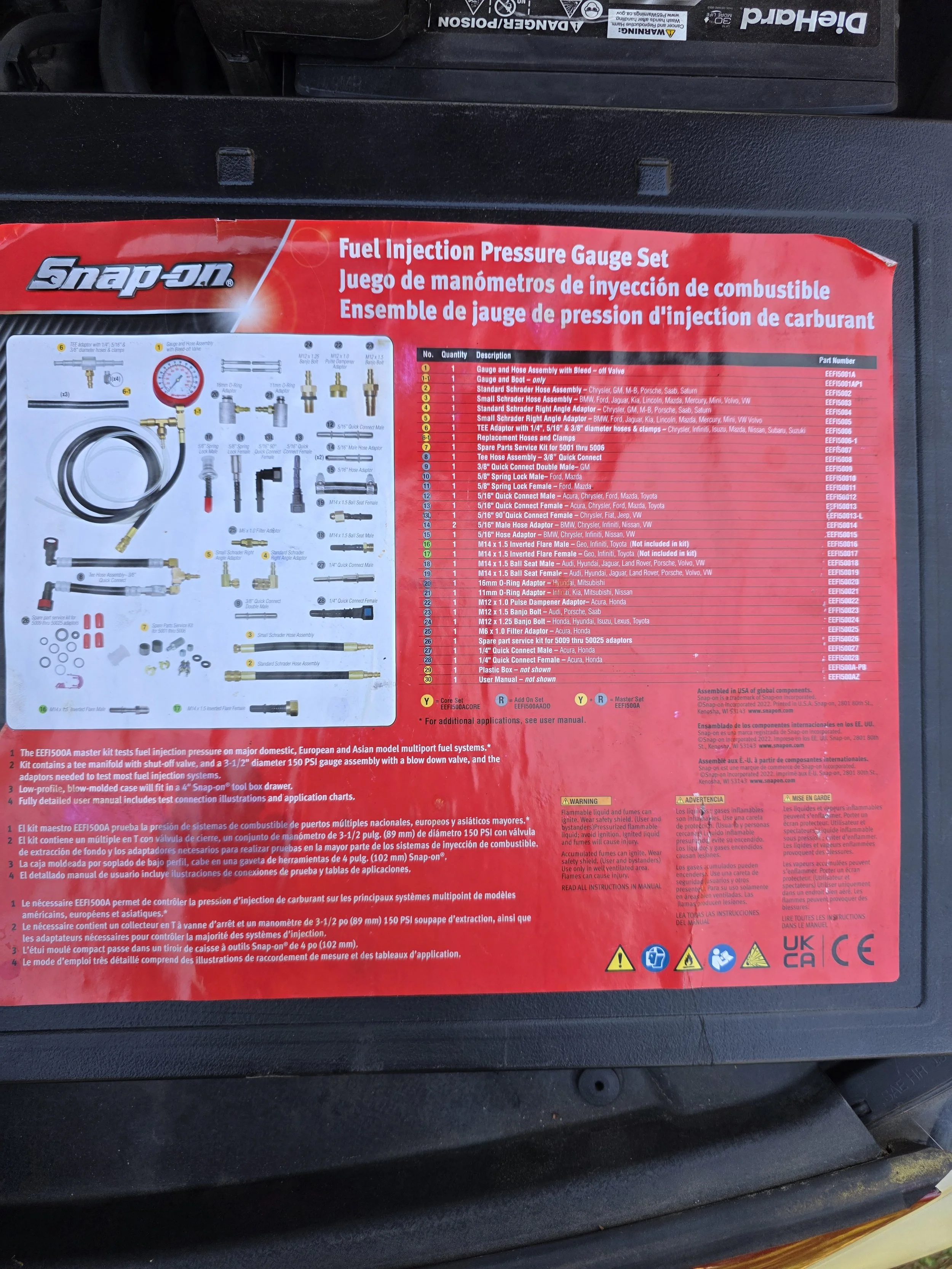 Red and black Snap-on Fuel Injection Pressure Gauge Set label on a black surface.
