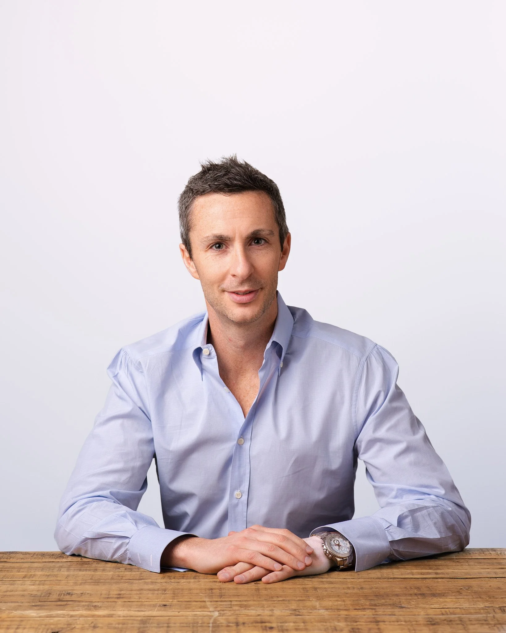 Business headshot taken by professional photographer in Brooklyn, combining sharp studio lighting with a relaxed, approachable tone.