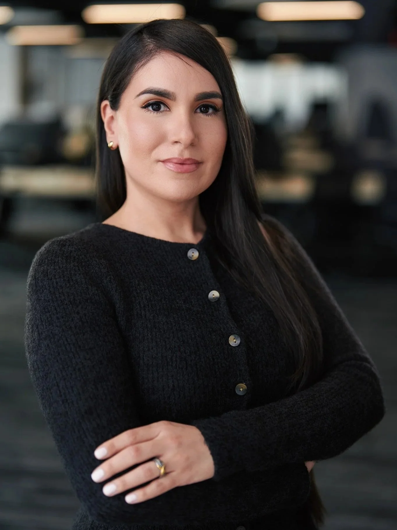 Corporate headshot of a woman photographed in a softly lit modern New York office with a softly blurred background