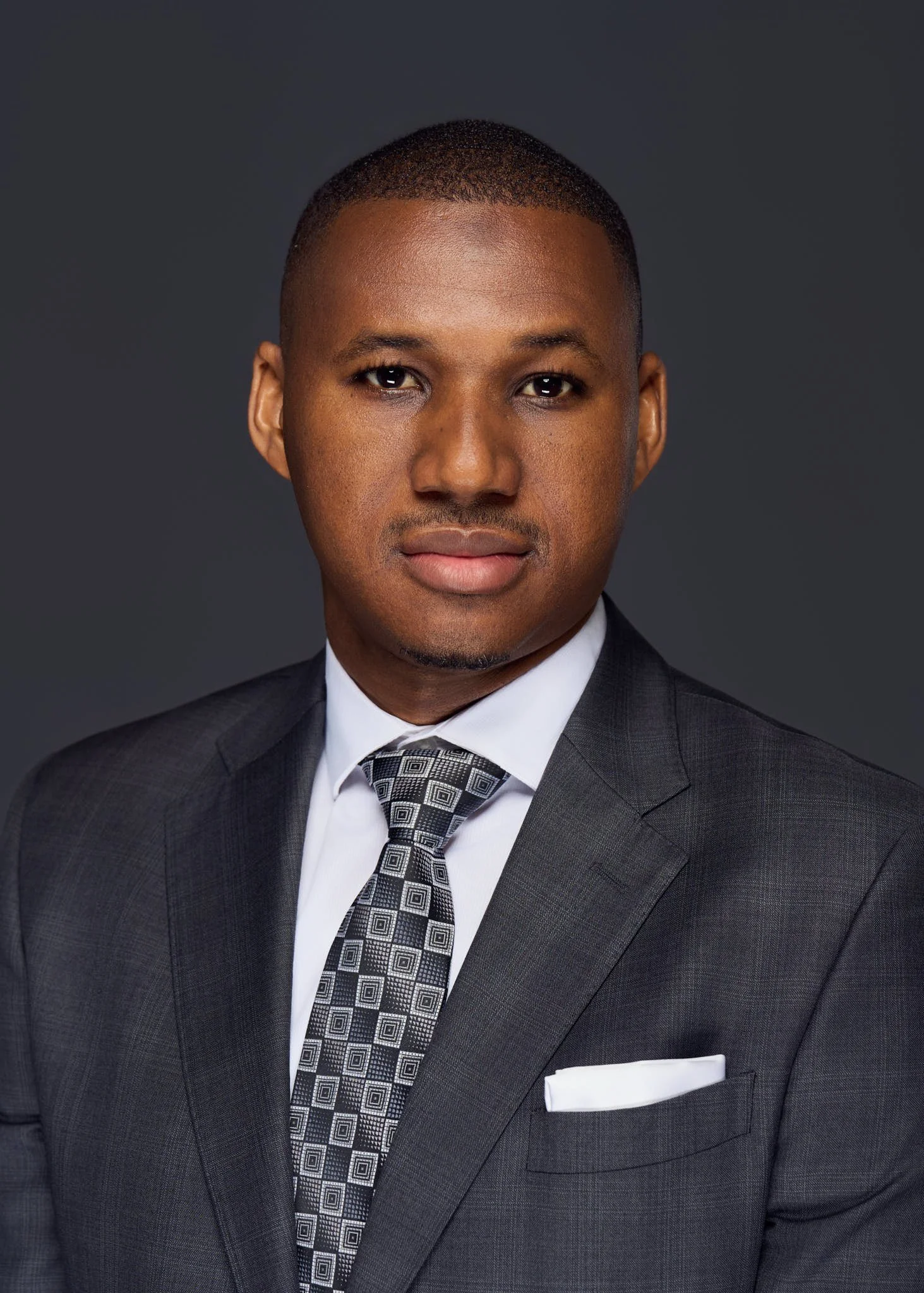 corporate_executive_headshot_gray_background_serious_expression_nyc_david_pexton_photography.jpg