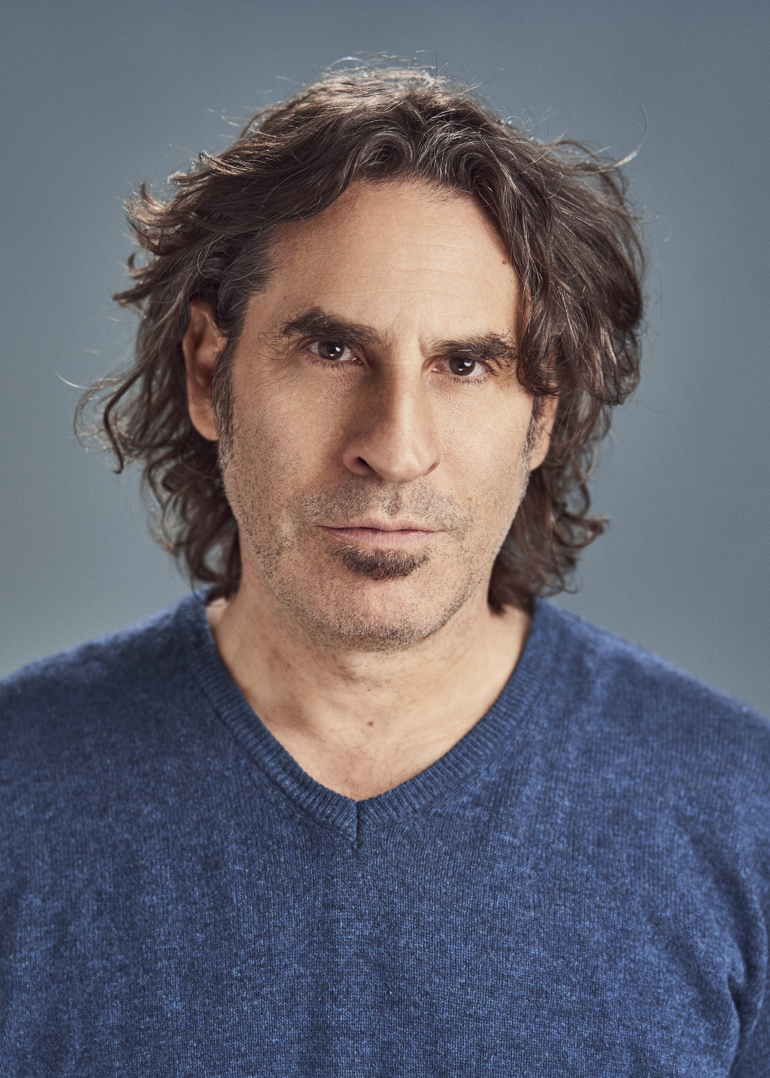 Actor headshot in New York City, tight portrait with shallow depth and soft grey background