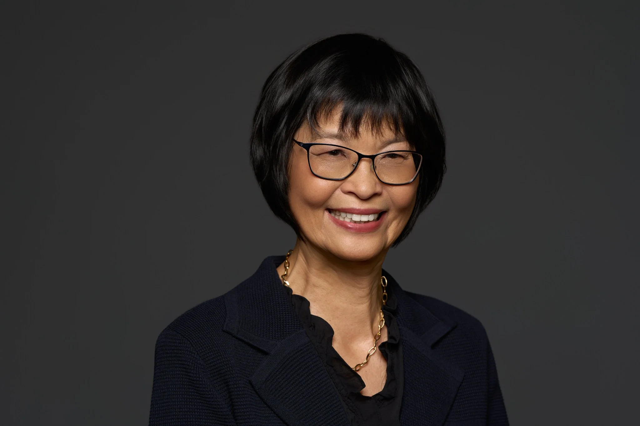 professional_woman_headshot_confident_gray_background_nyc_david_pexton_photography.jpg