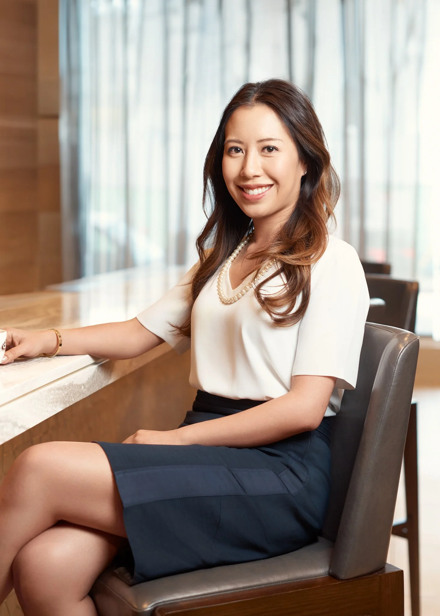 Corporate lifestyle portrait of a woman photographed in a New York City office or reception setting
