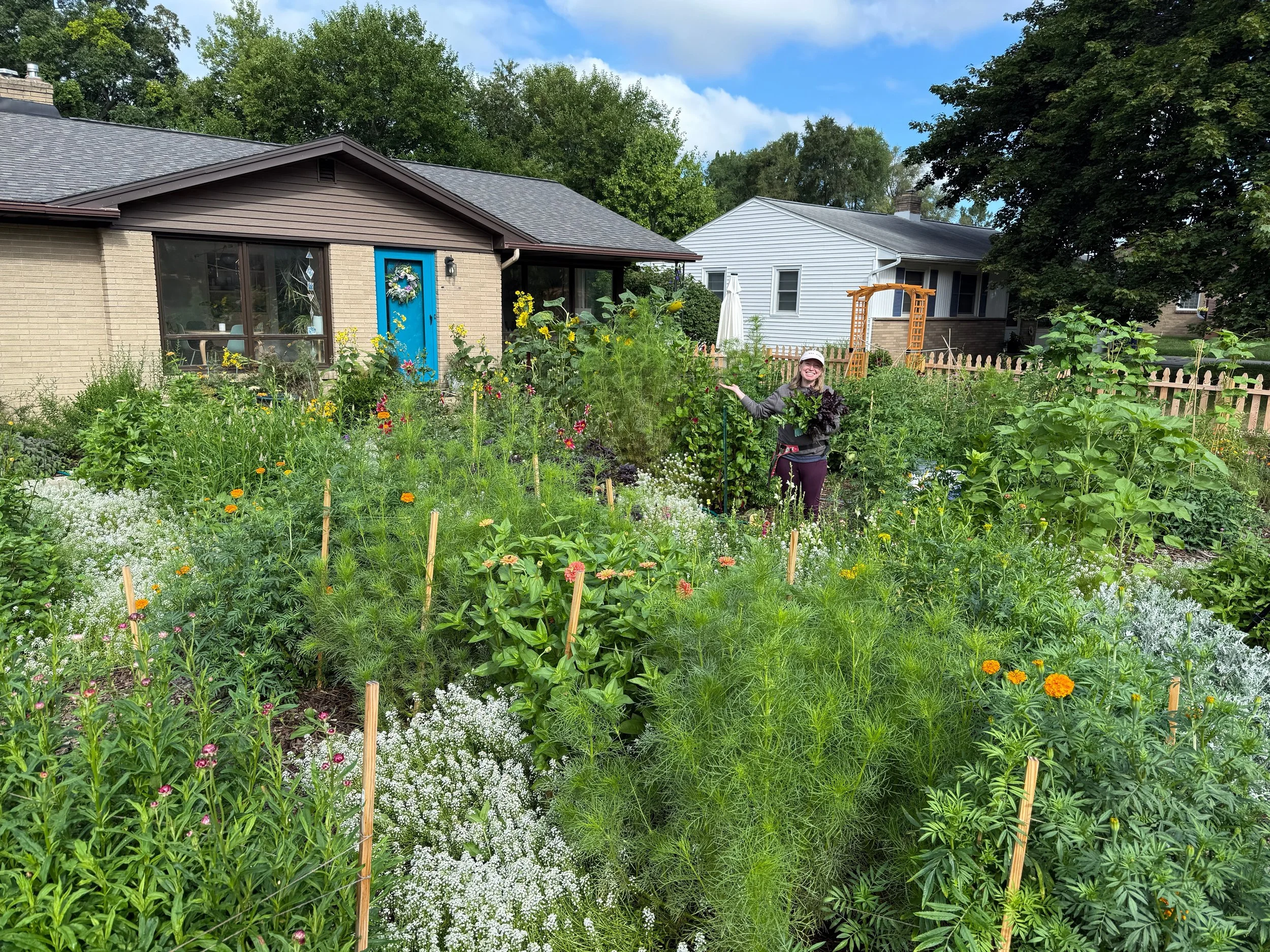 Front yard garden filled with flowers, native plants, and smiling faces