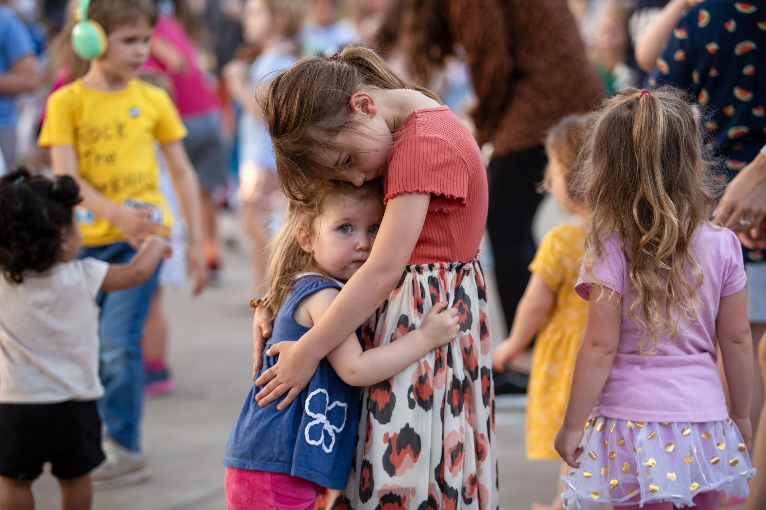 Sisters Iva, age 7, and Kaia, age 2, hug at Rock the Park on Oct. 25, 2024. 