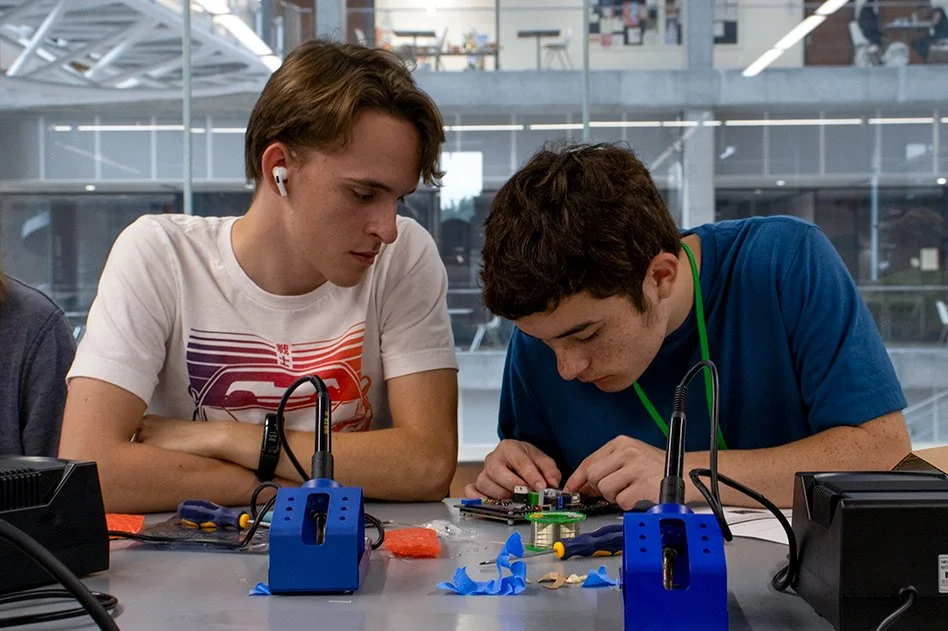 Students in the UT Computer Science Summer Academies work to construct test robotics devices.