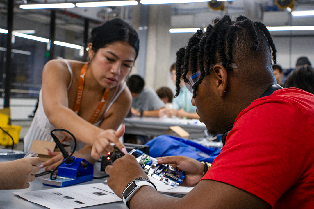 Students in the UT Computer Science Summer Academies work to construct test robotics devices.