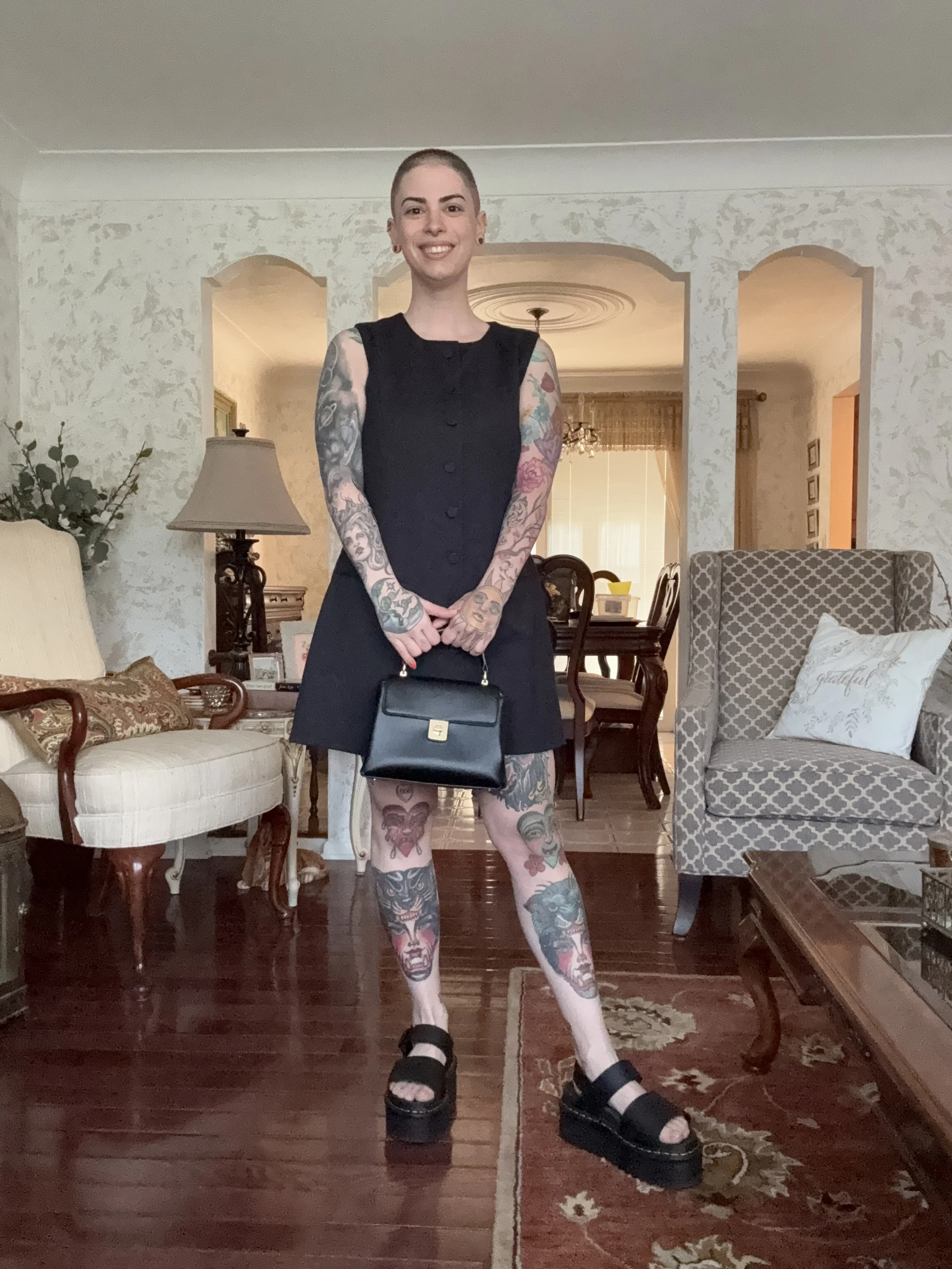 Picture of a woman with short dark hair in a black mini dressy.